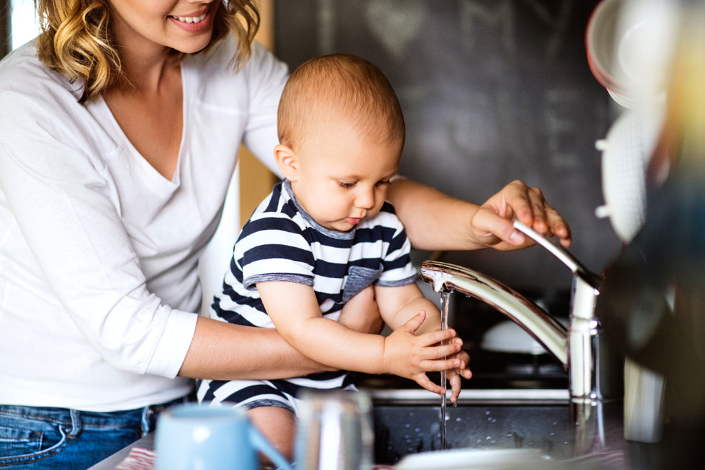 Young mother with a baby boy doing housework. by Jozef Polc on 500px.com