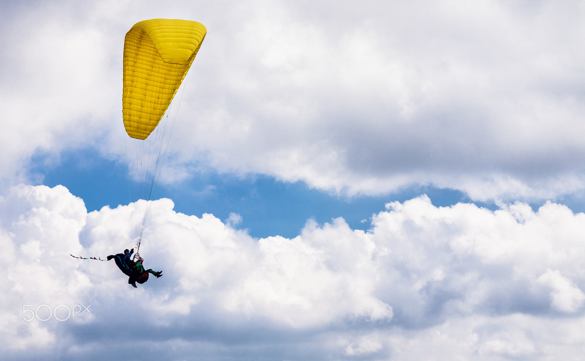 Tandem paragliding flight in clouds