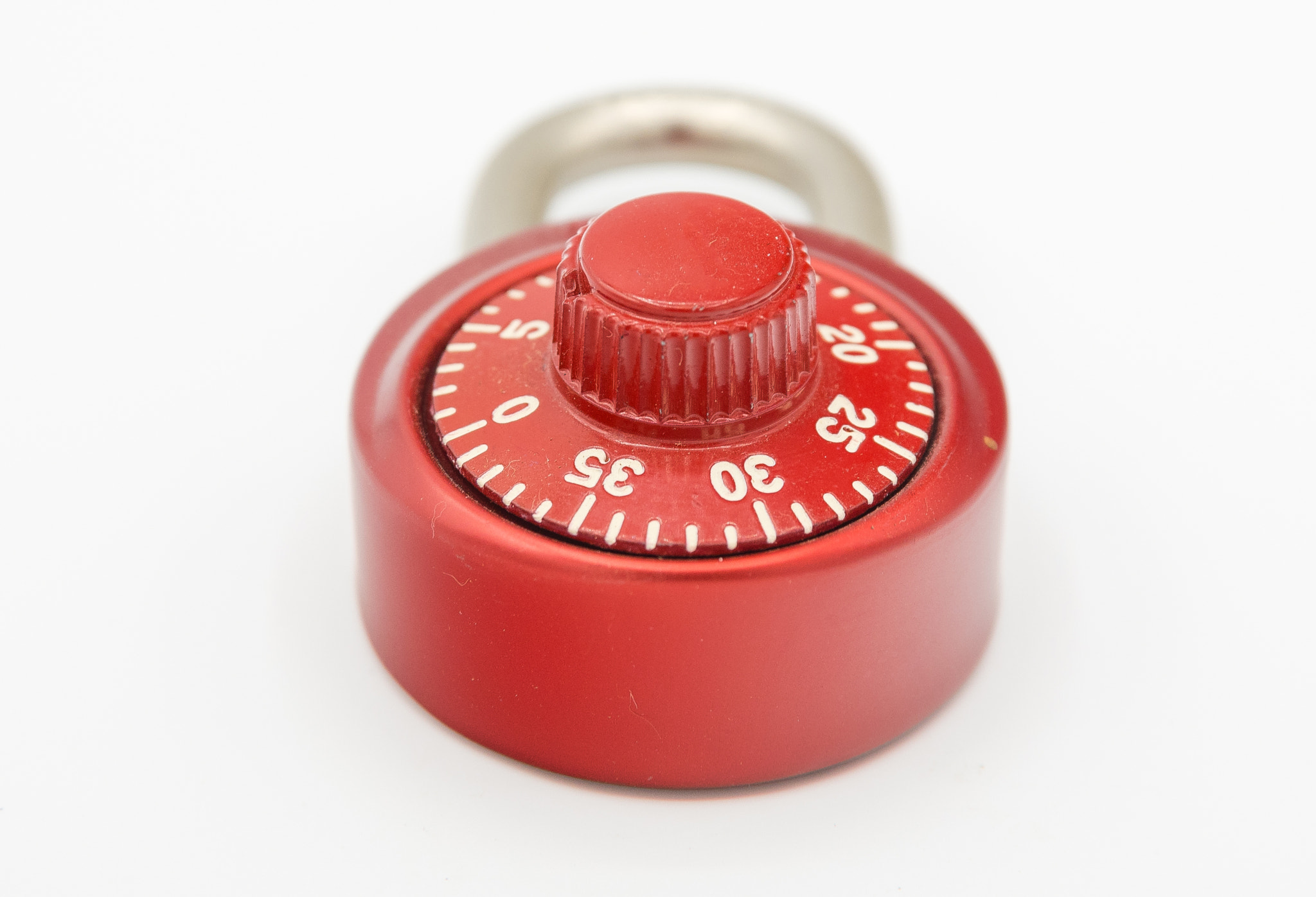 Red stainless steel lock on a white background