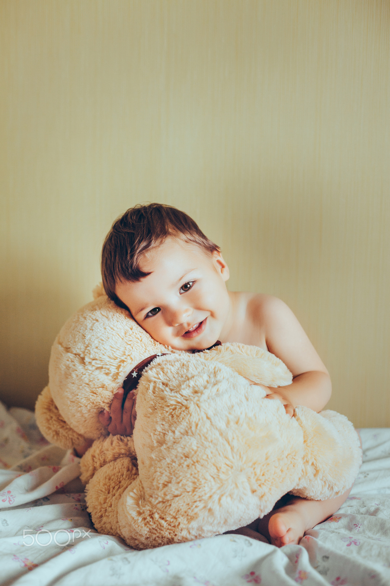 smiling kid with teddy bear