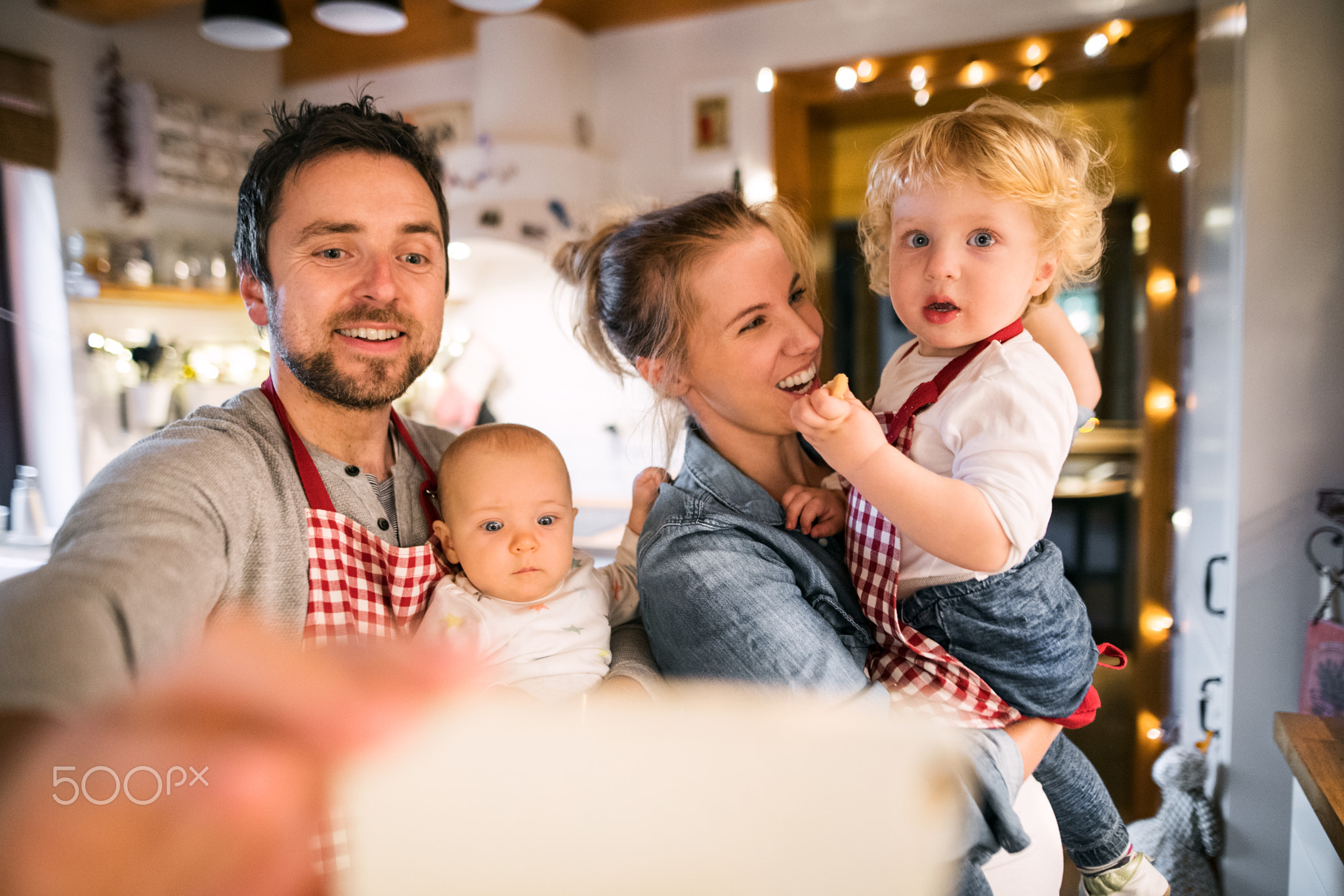 Young family making cookies at home.