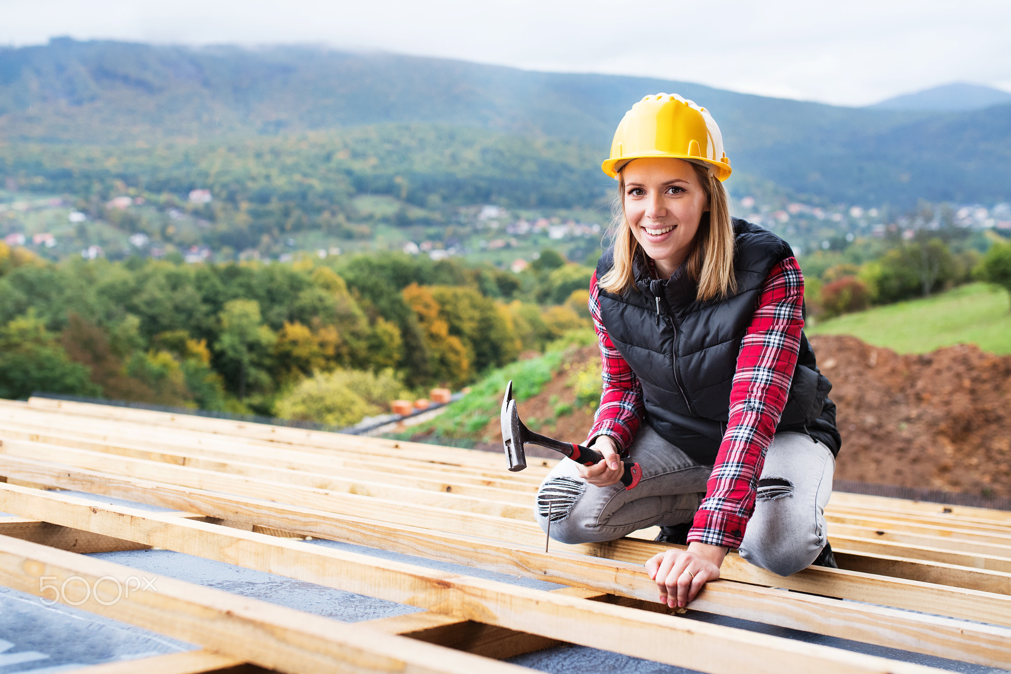 Young woman worker on the construction site.