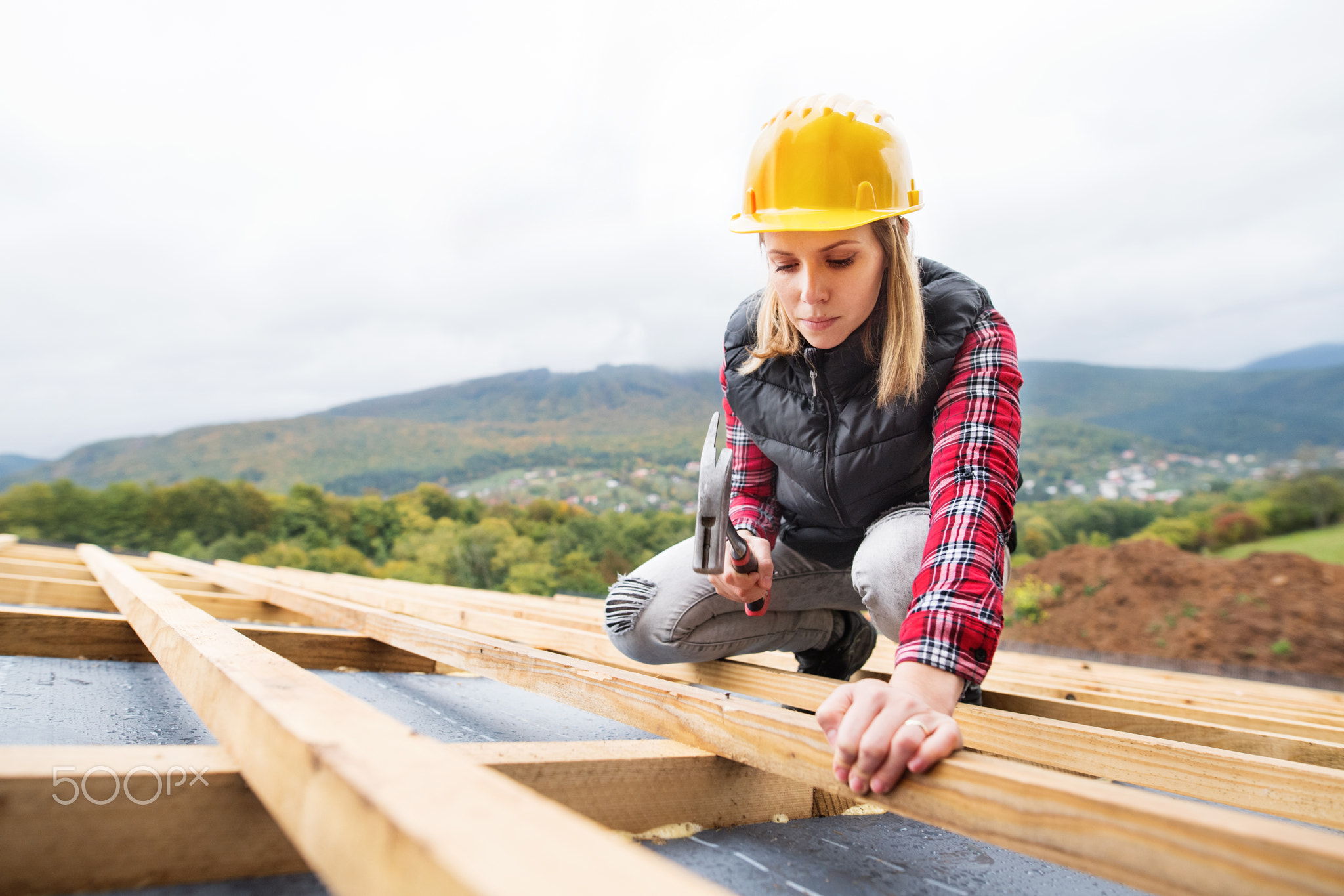 Young woman worker on the construction site.