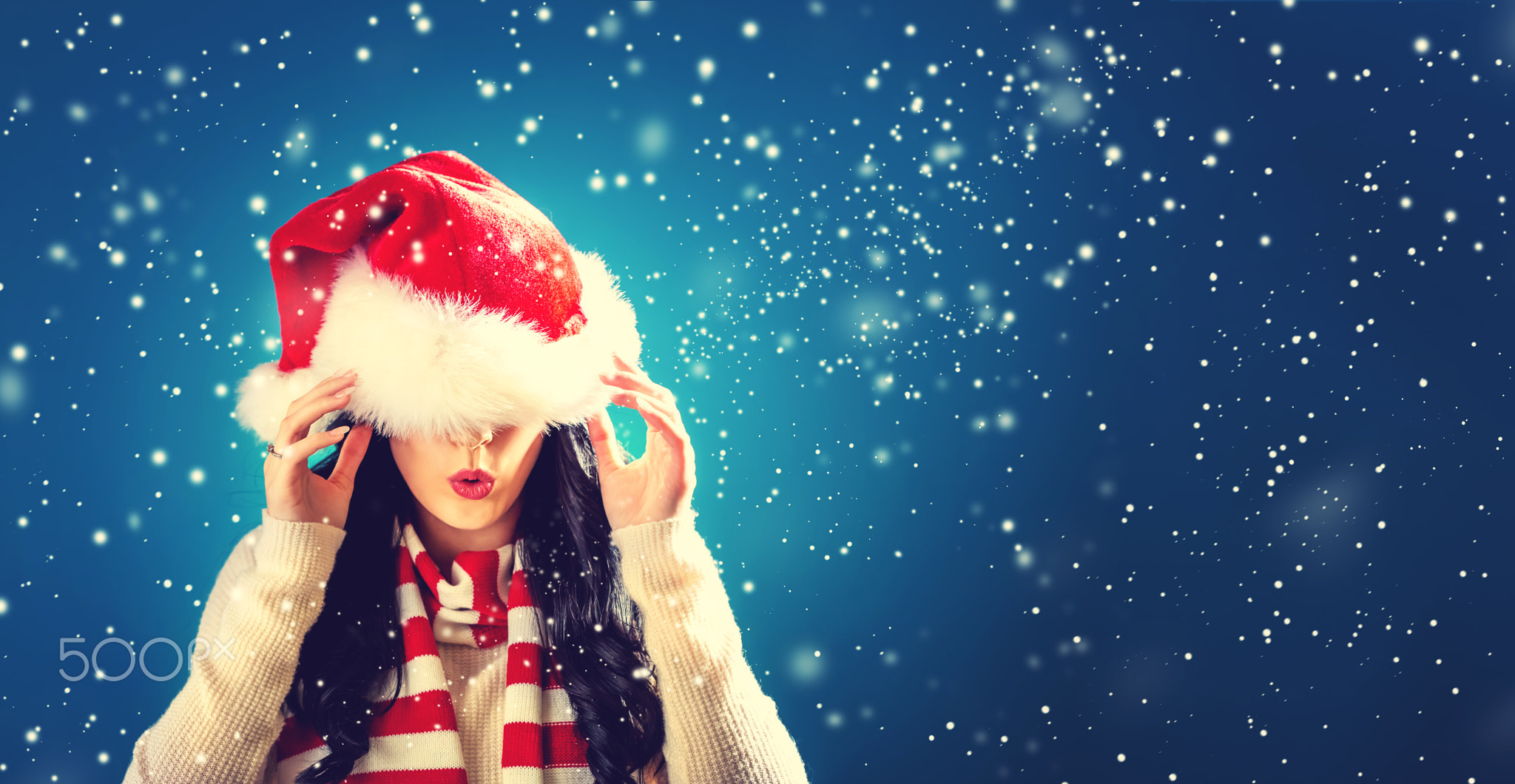 Woman with Santa hat pulled over her eyes