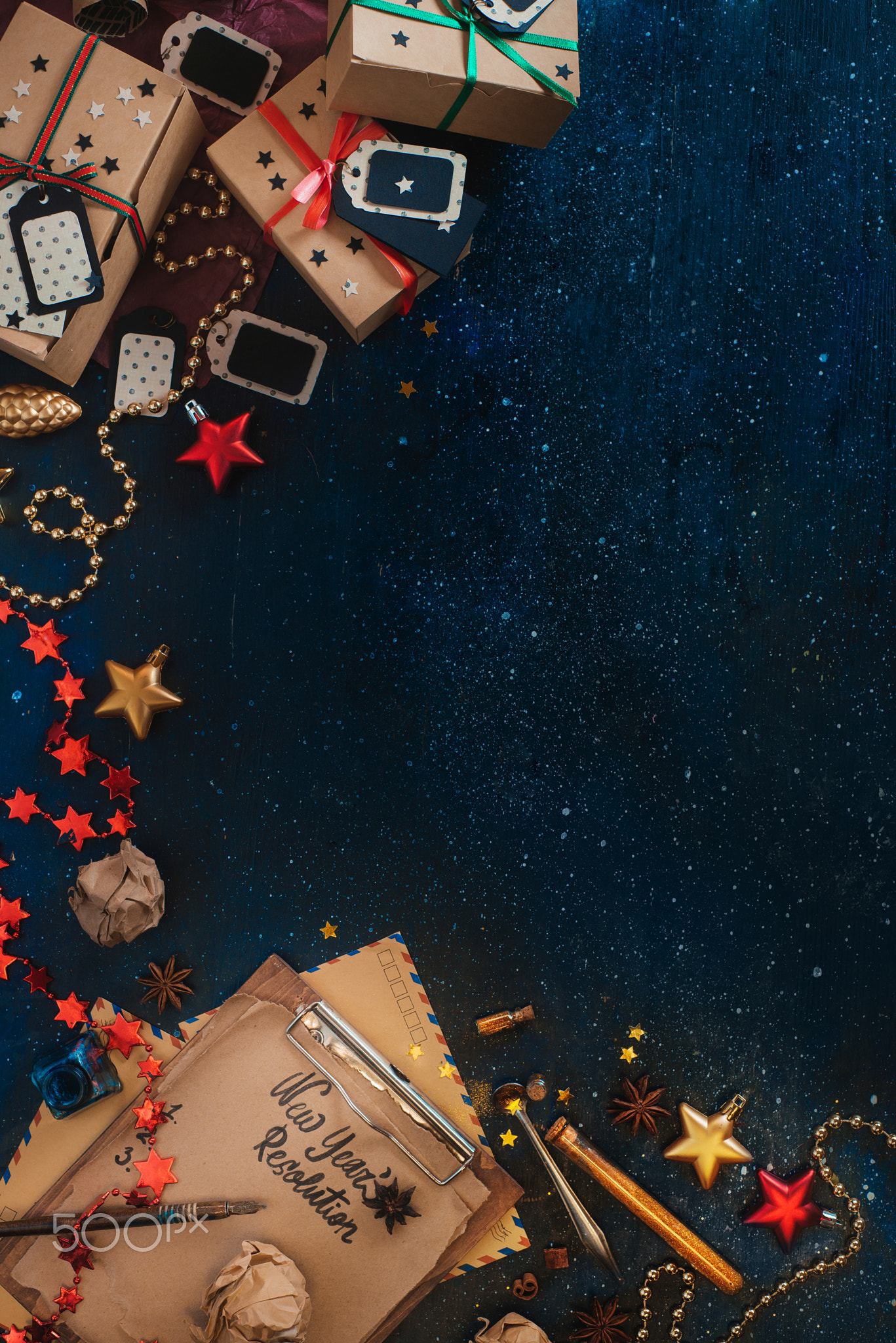 Frame with New Year resolution concept. Christmas celebration dark flat lay with presents, stars,...
