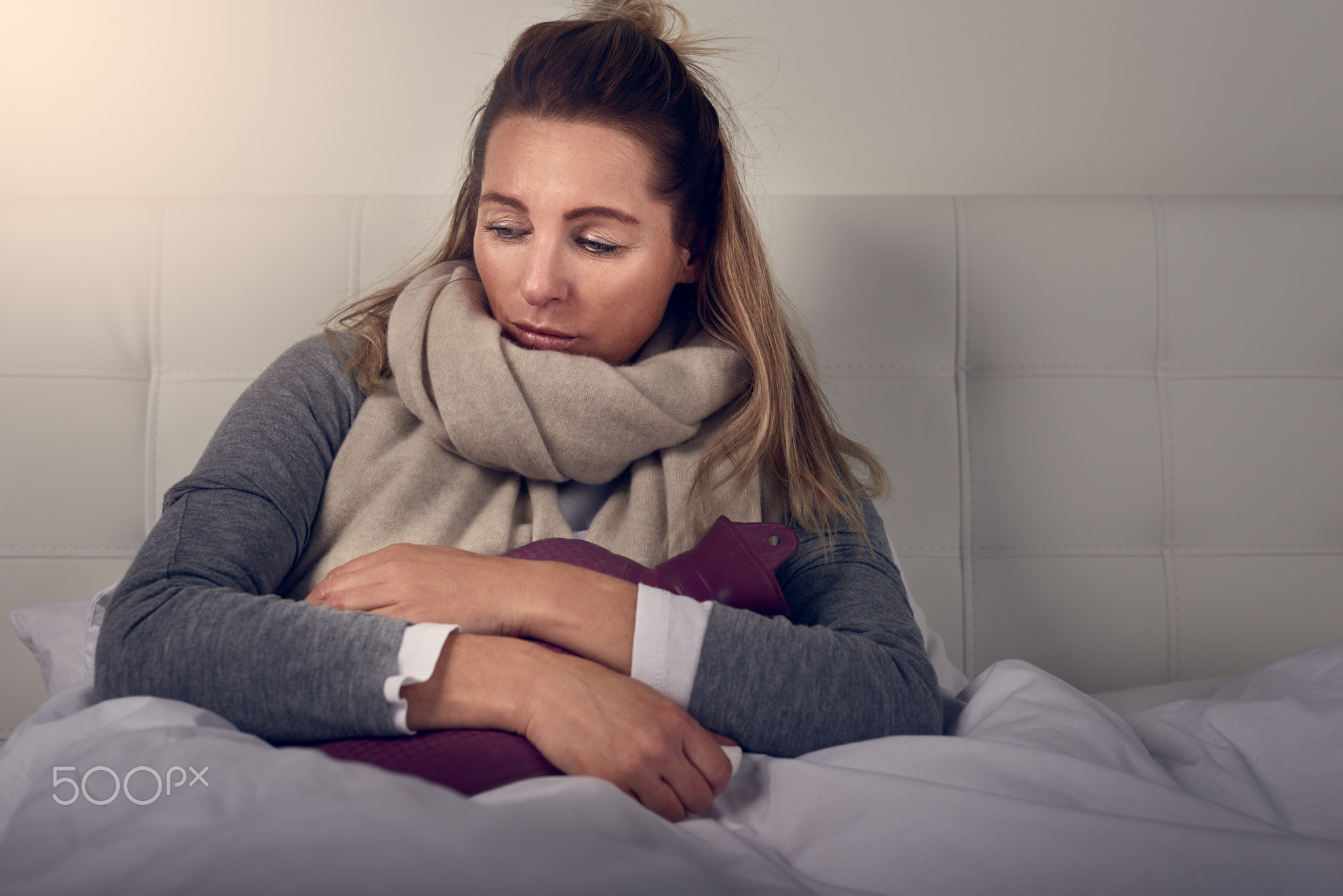 Sick woman using nasal spray