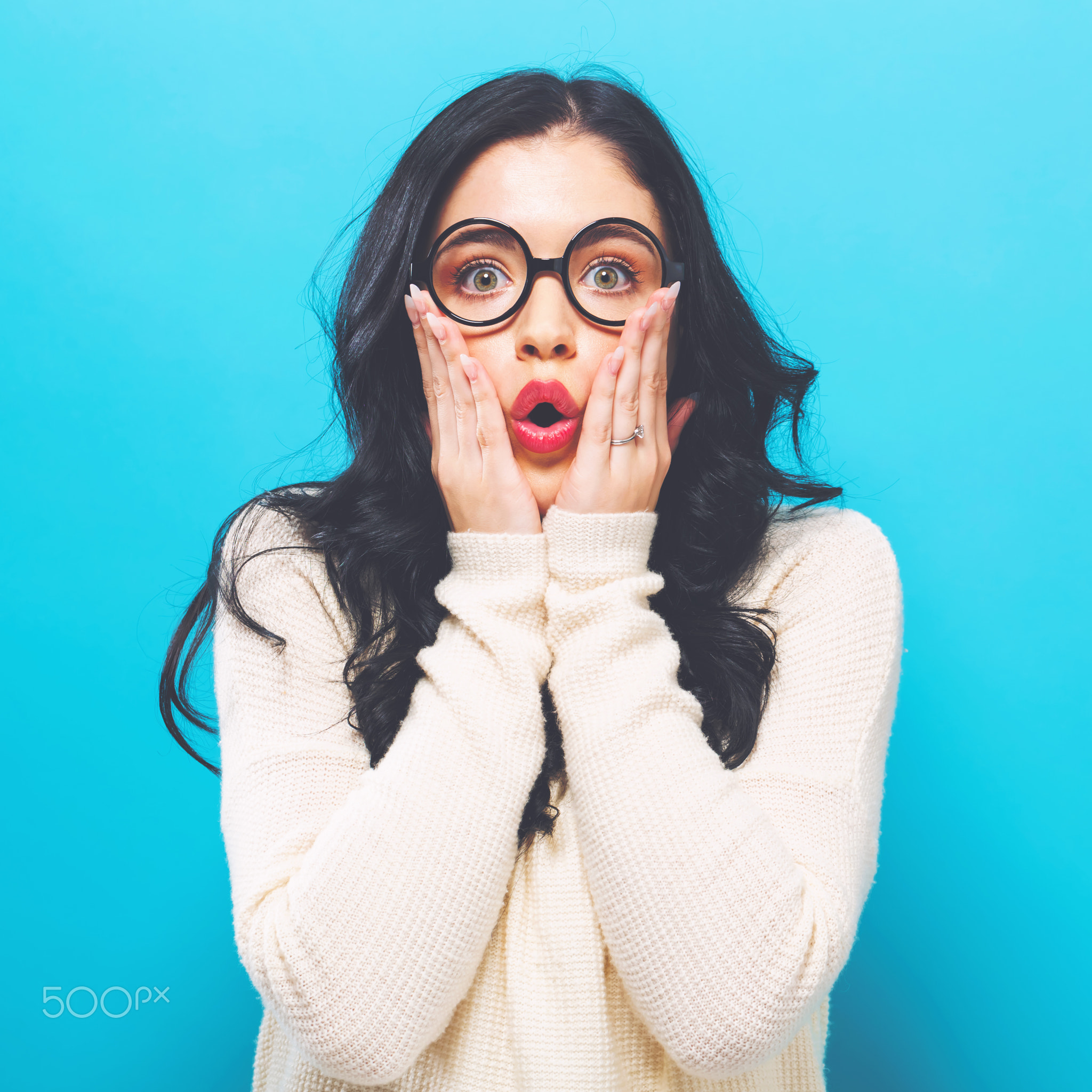 Surprised young woman on a bright background