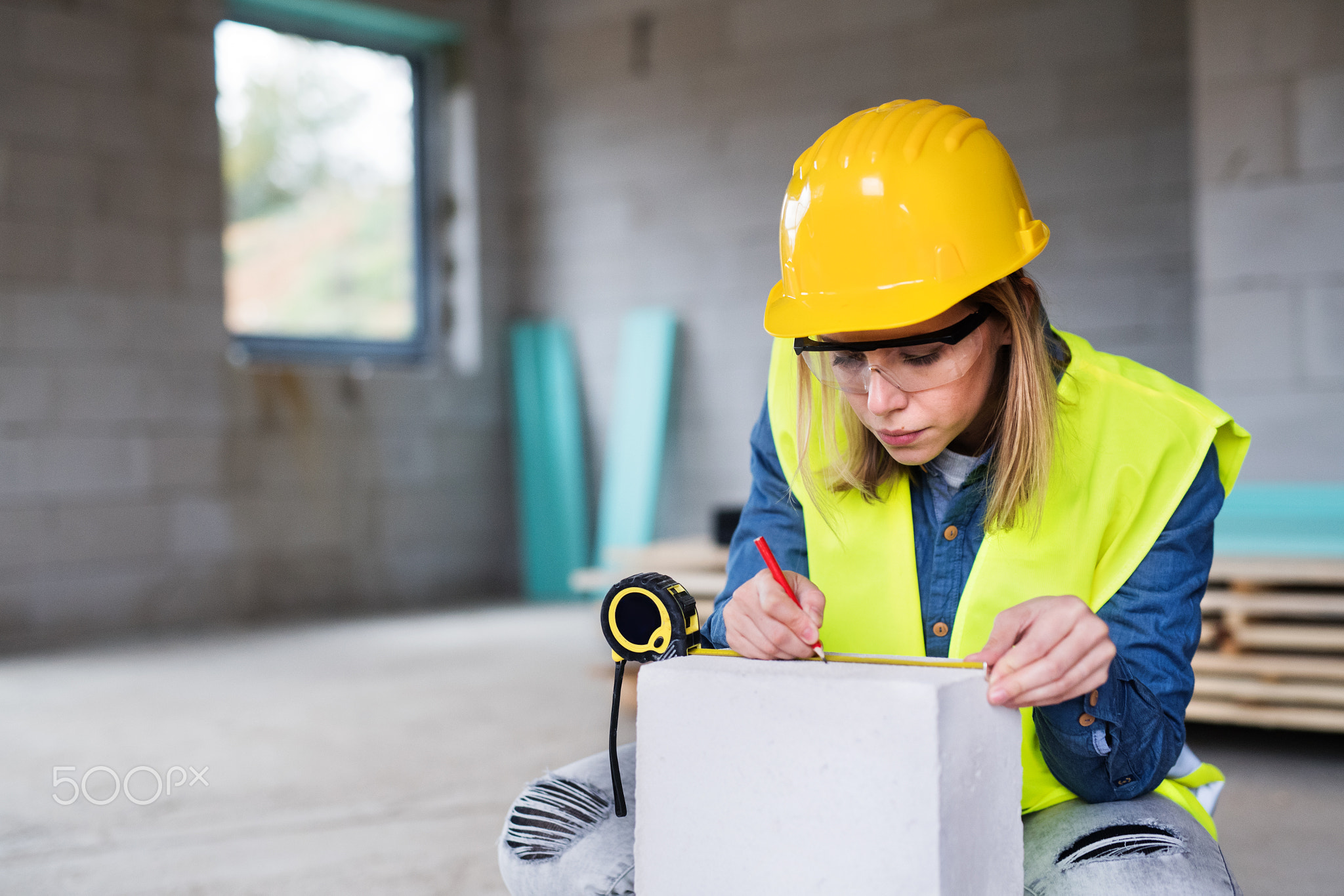 Young woman worker on the building site.