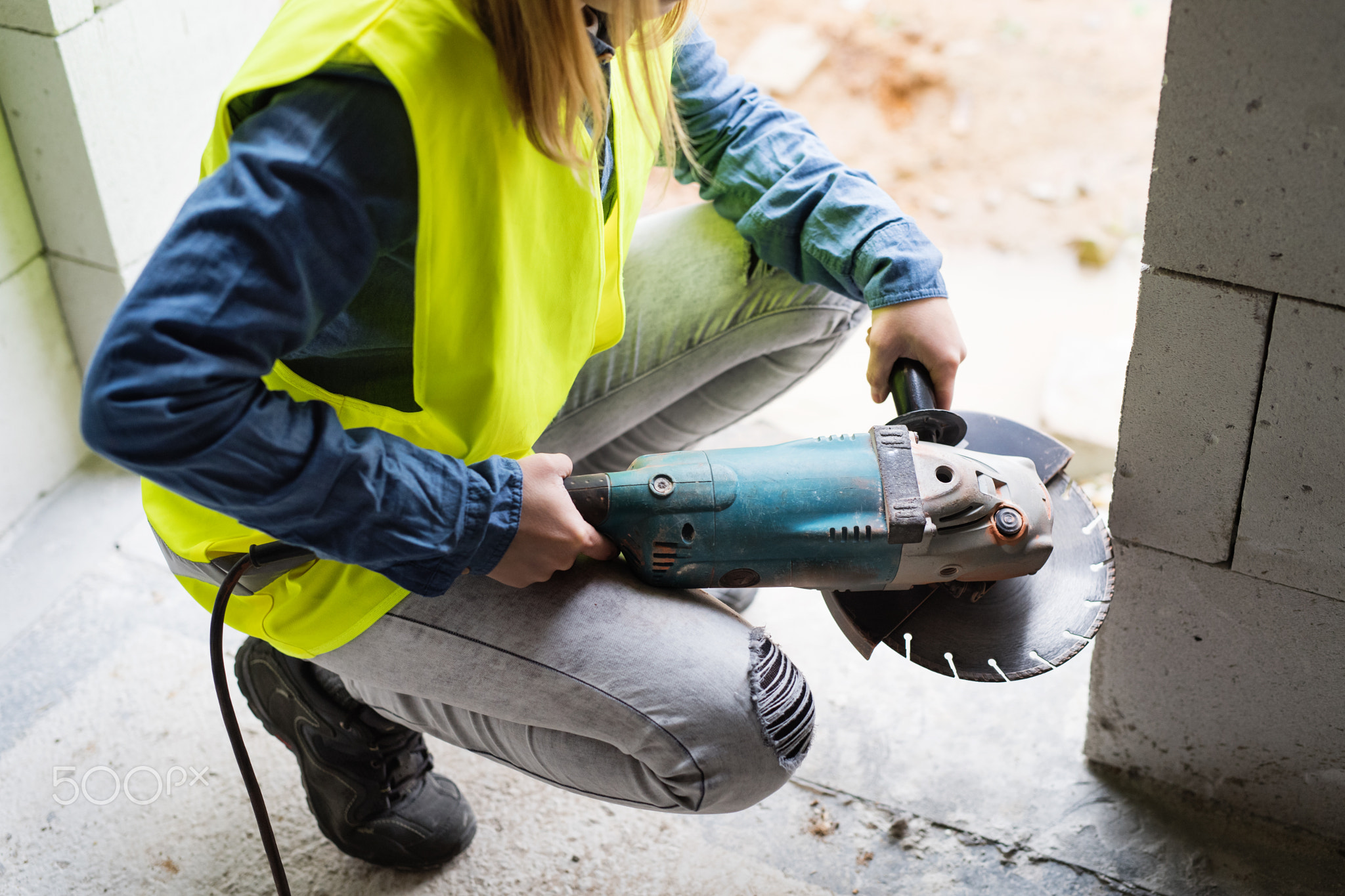 Young woman worker on the construction site.