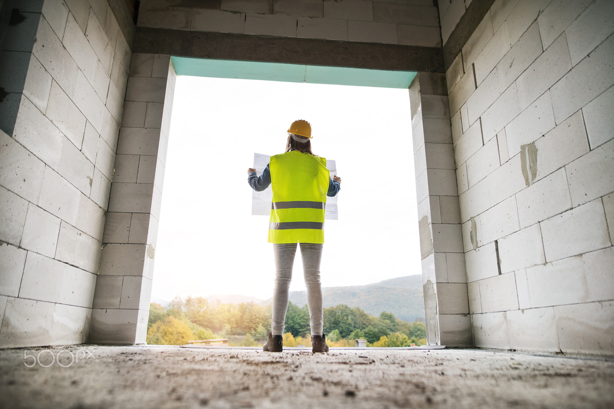 Young woman worker on the building site.