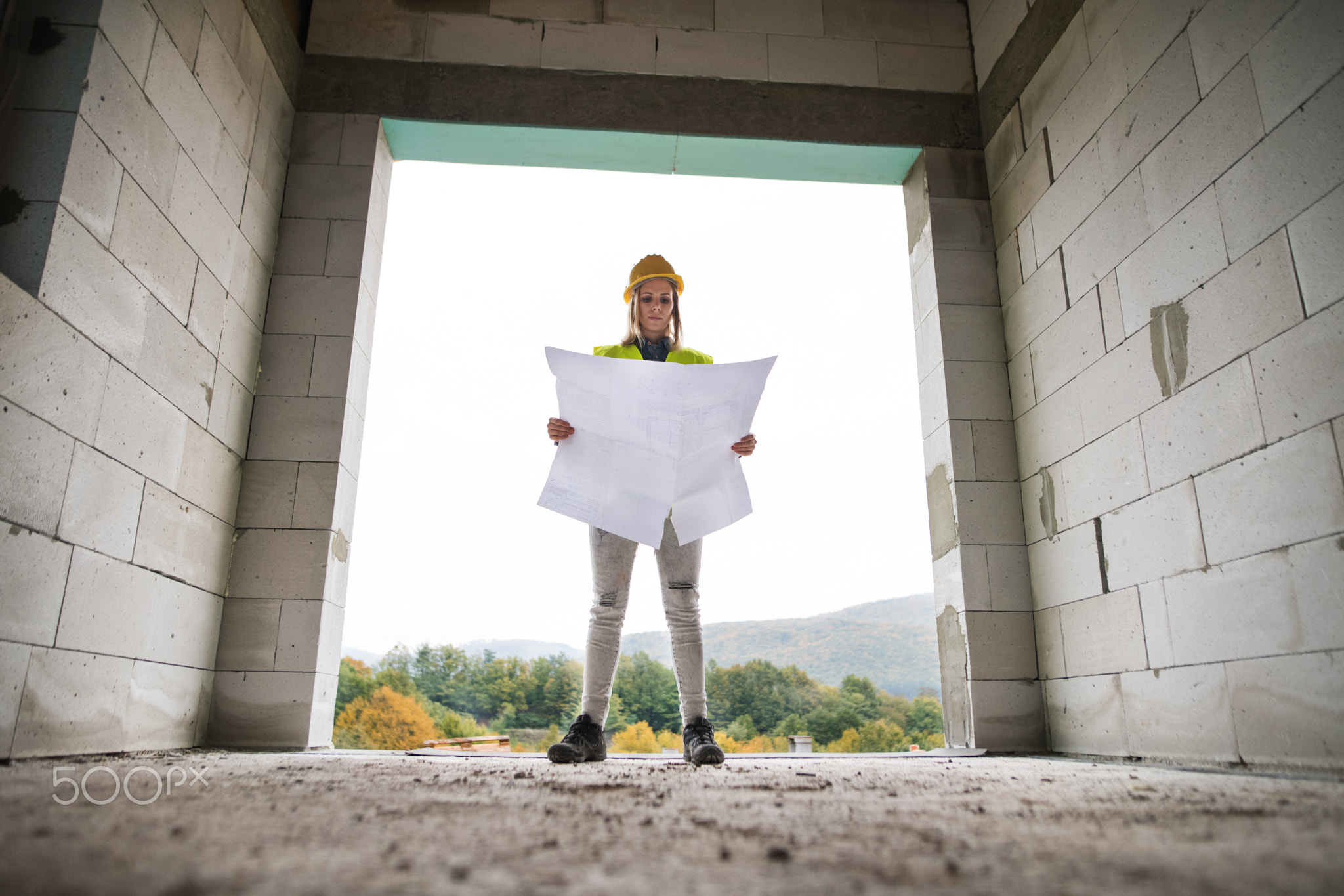 Young woman worker on the building site.