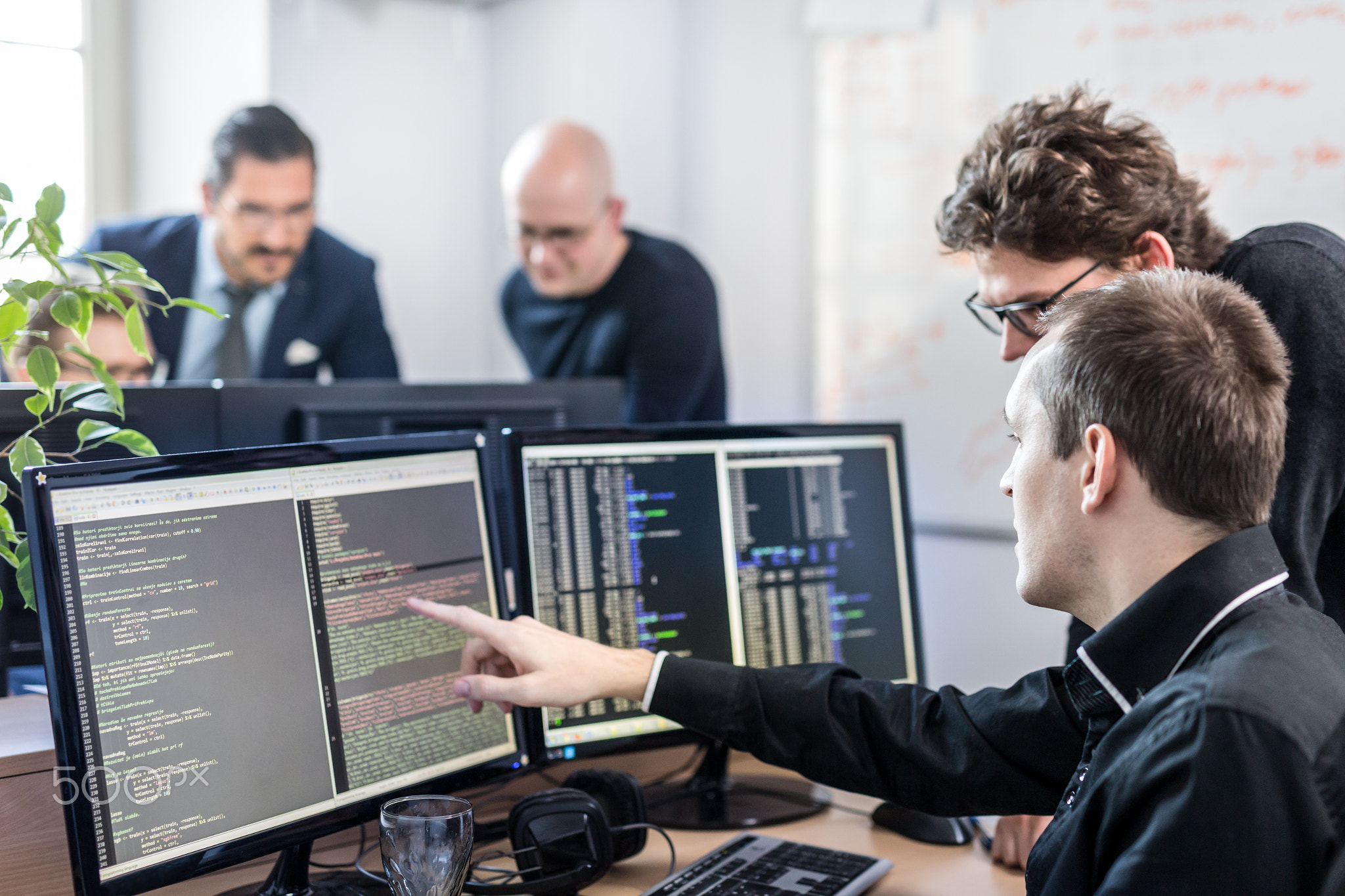 Startup business problem solving. Software developers working on desktop computer.