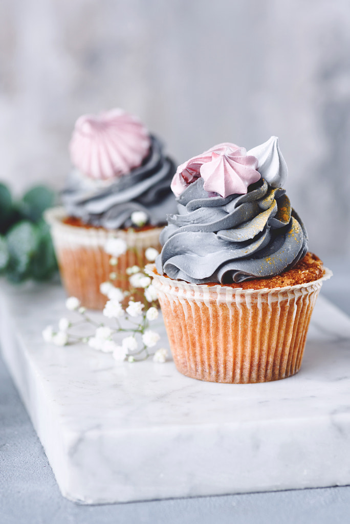 Cupcakes with grey buttercream frosting and meringue kisses on marble board. by Vladislav Nosick on 500px.com