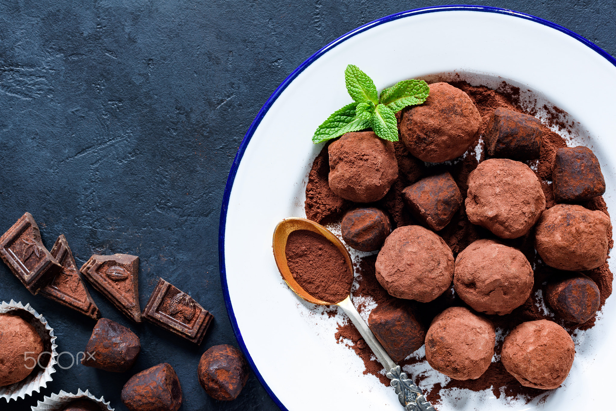 Homemade raw chocolate truffles decorated with mint and dark chocolate