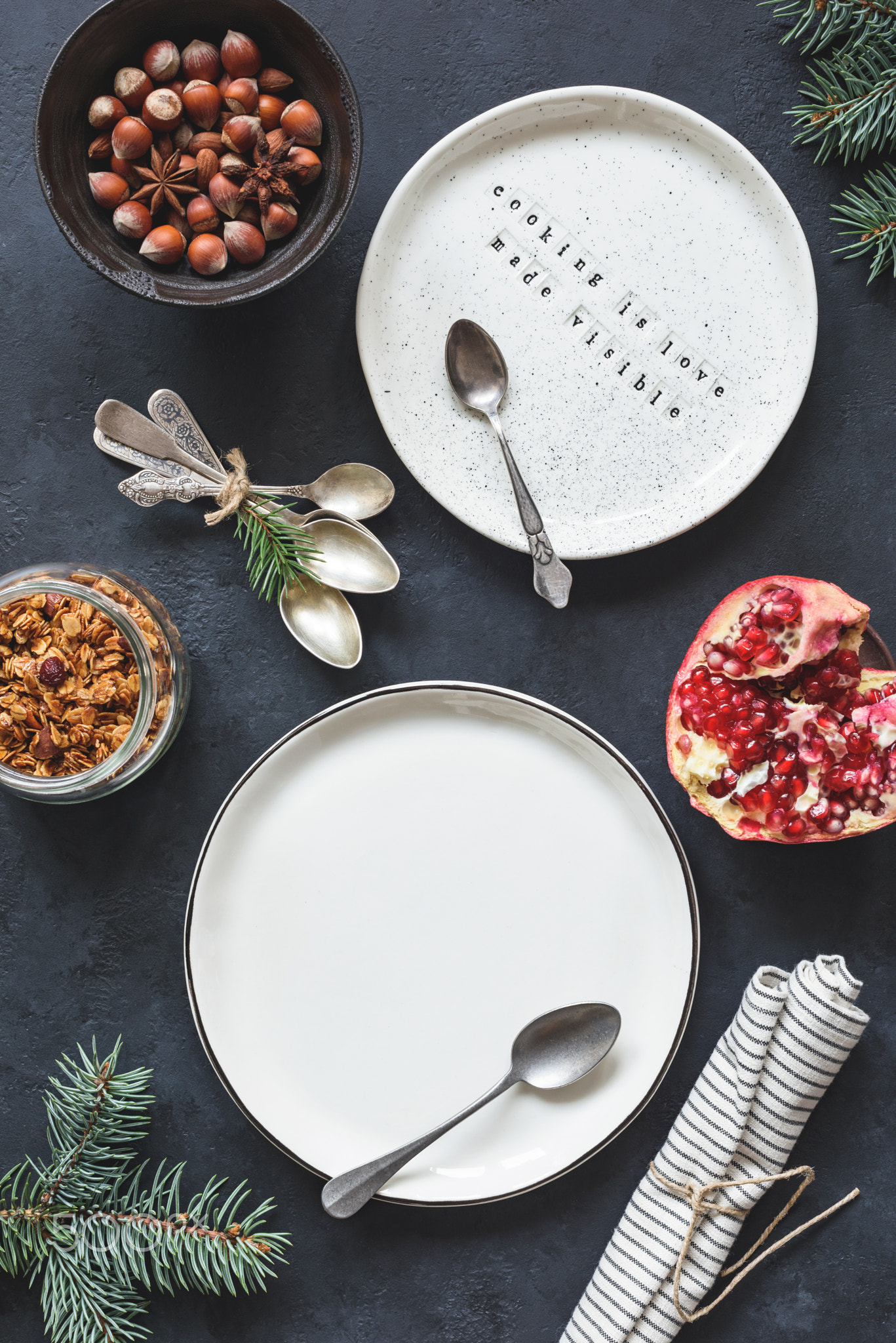 Table setting with empty white plates, vintage tea spoons, napkin