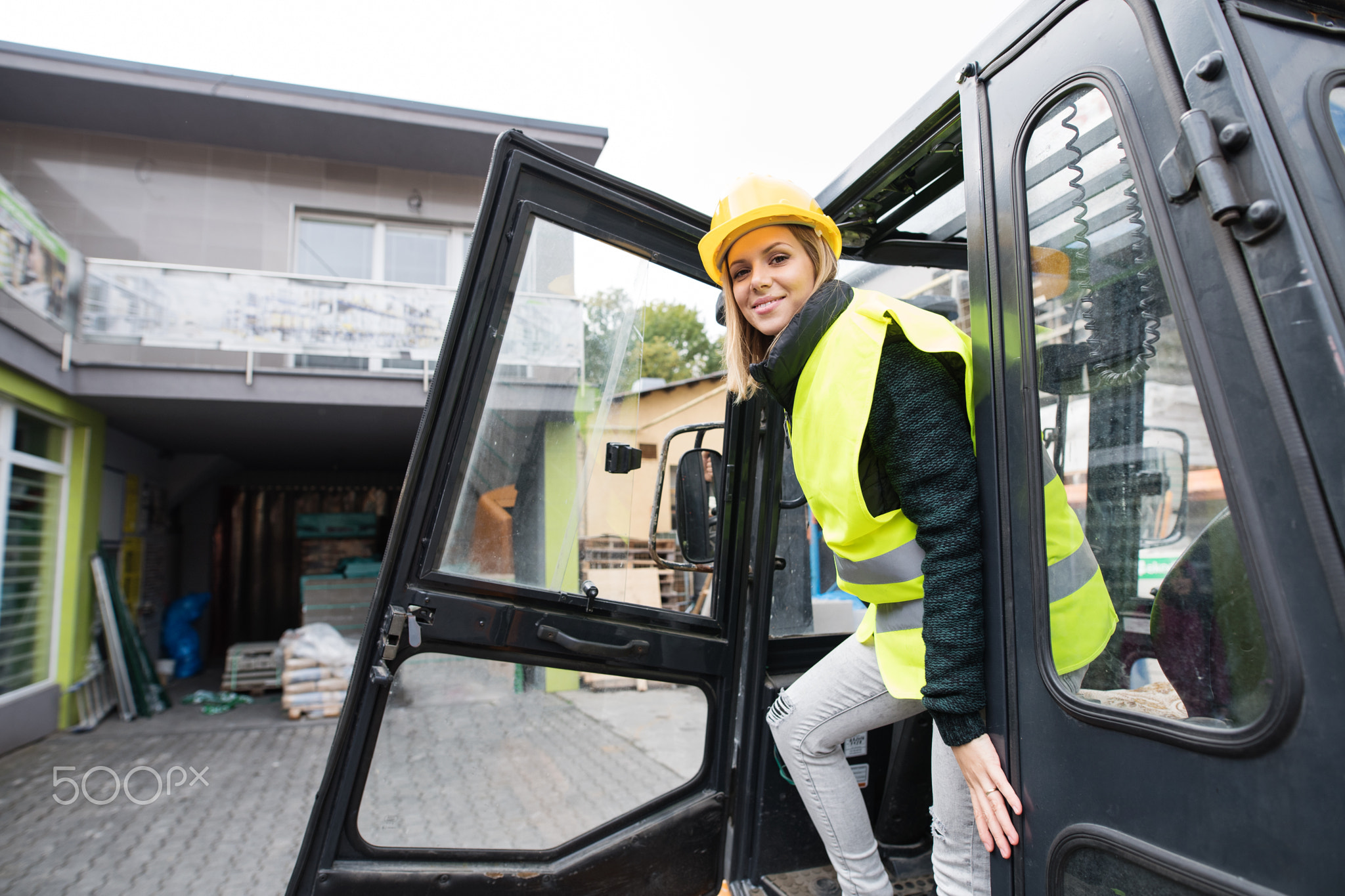 Woman forklift truck driver in an industrial area.