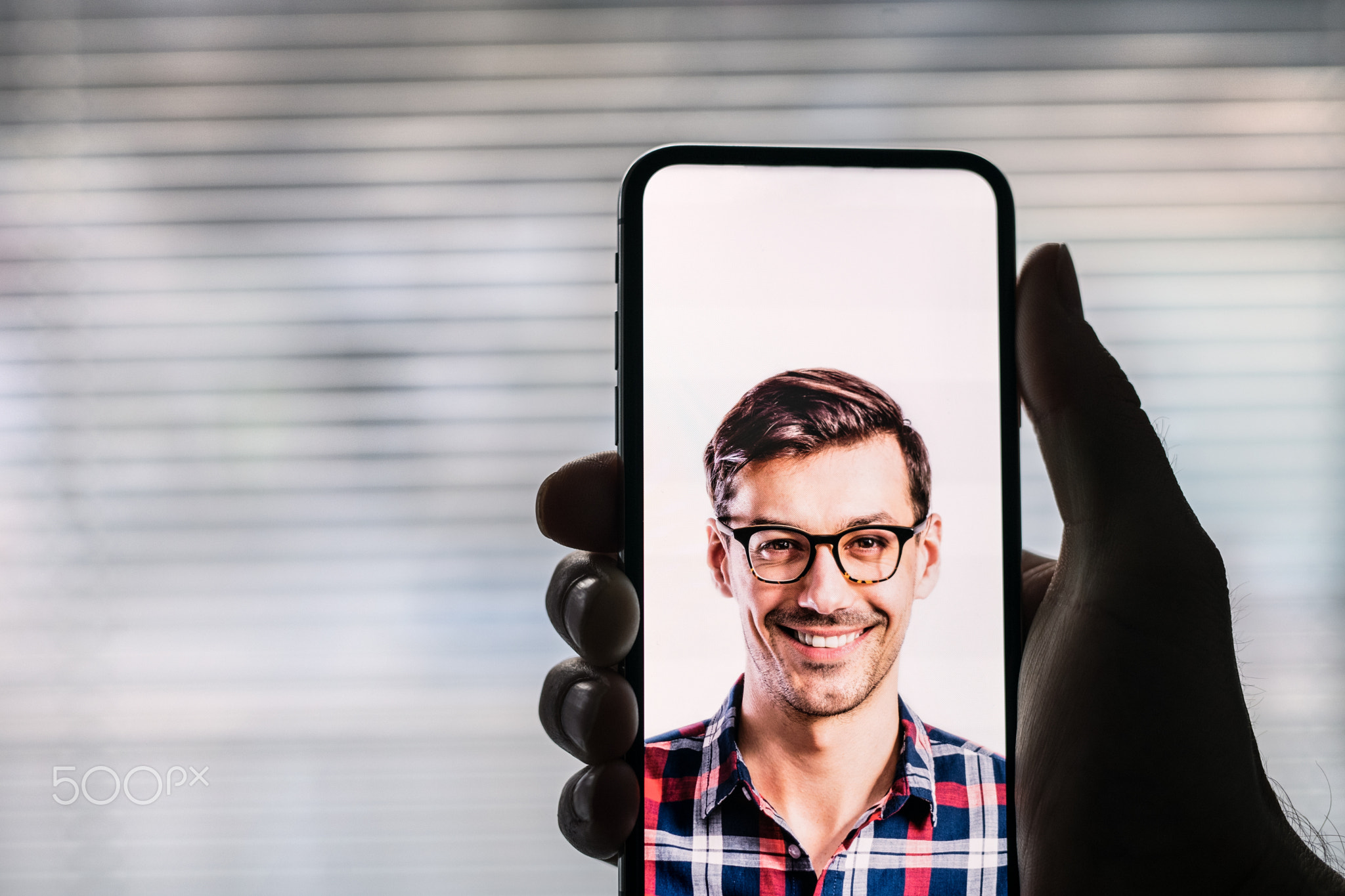 A smartphone using face ID recognition system.