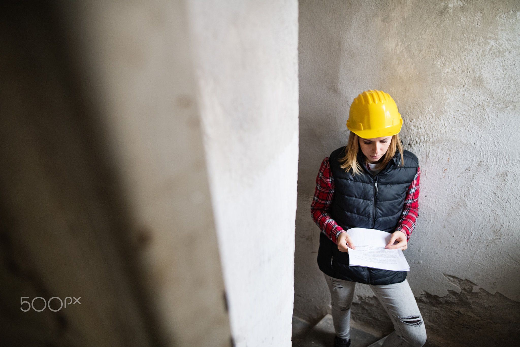 Young woman worker on the building site.