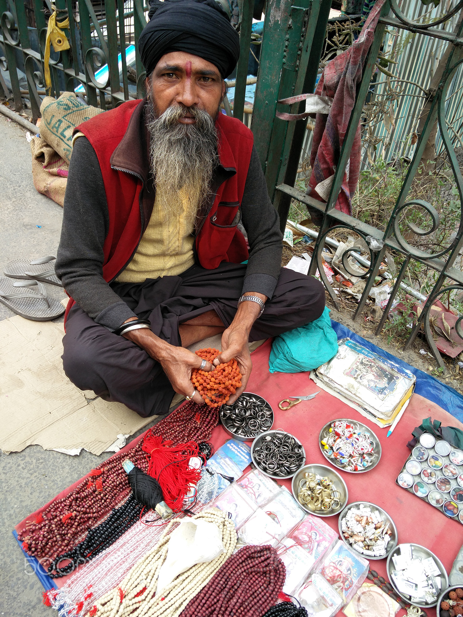 A man selling beads, coins, antiques, artifacts