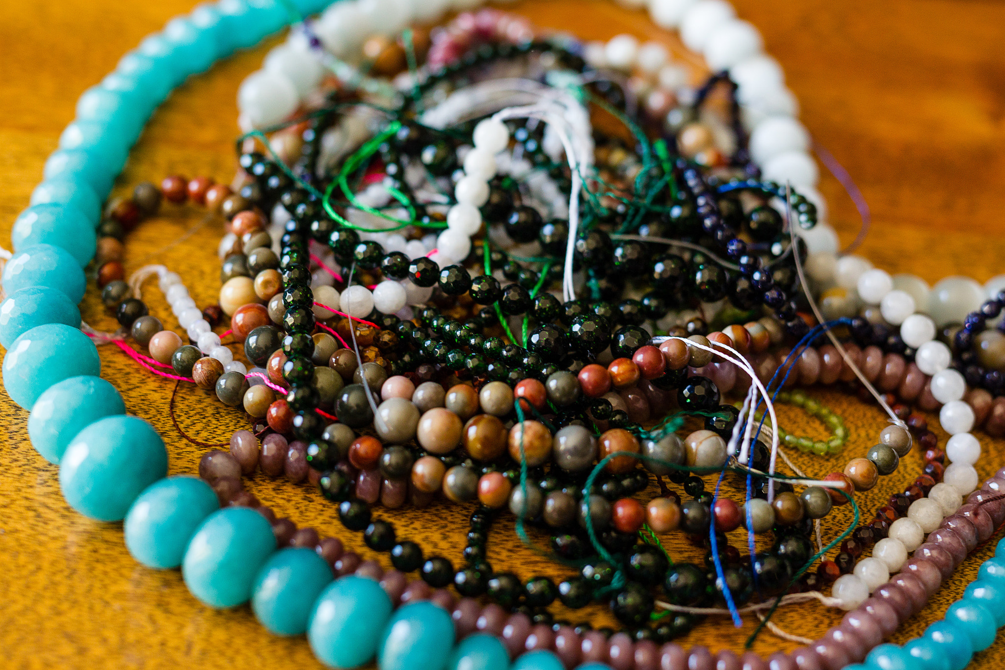pile of bead strands waiting to be made into jewelry