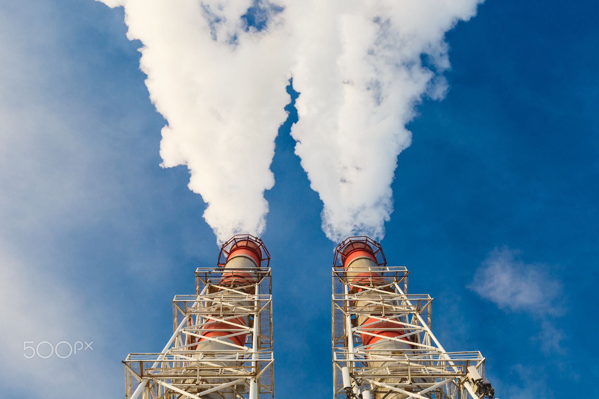 Stream of dark smoke from the chimney of factory