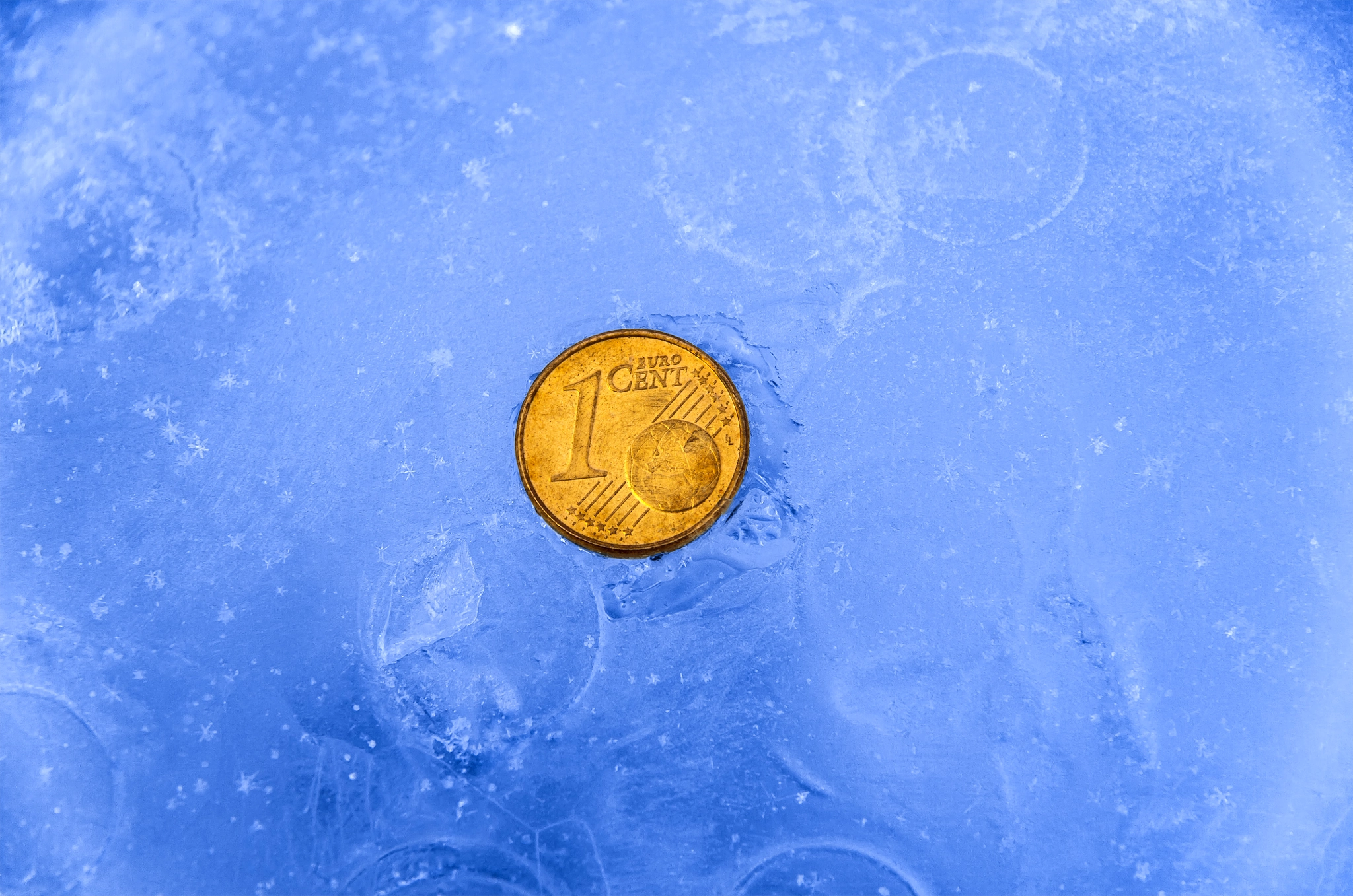 1 gold cent coin in ice