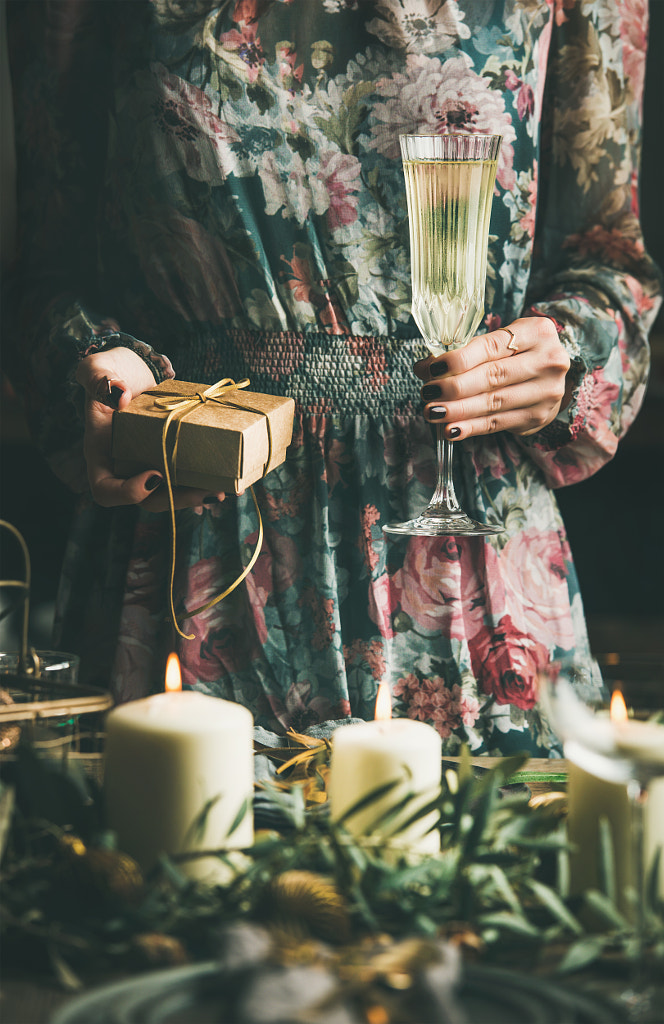 Woman holding glass of champaigne and gift box, Christmas eve by Anna Ivanova on 500px.com