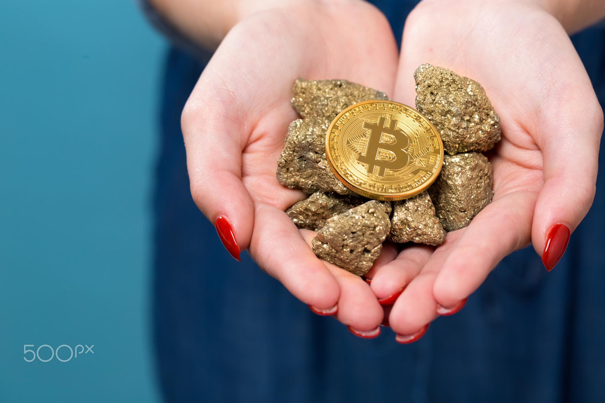 Woman holding a physical bitcoin cryptocurrency