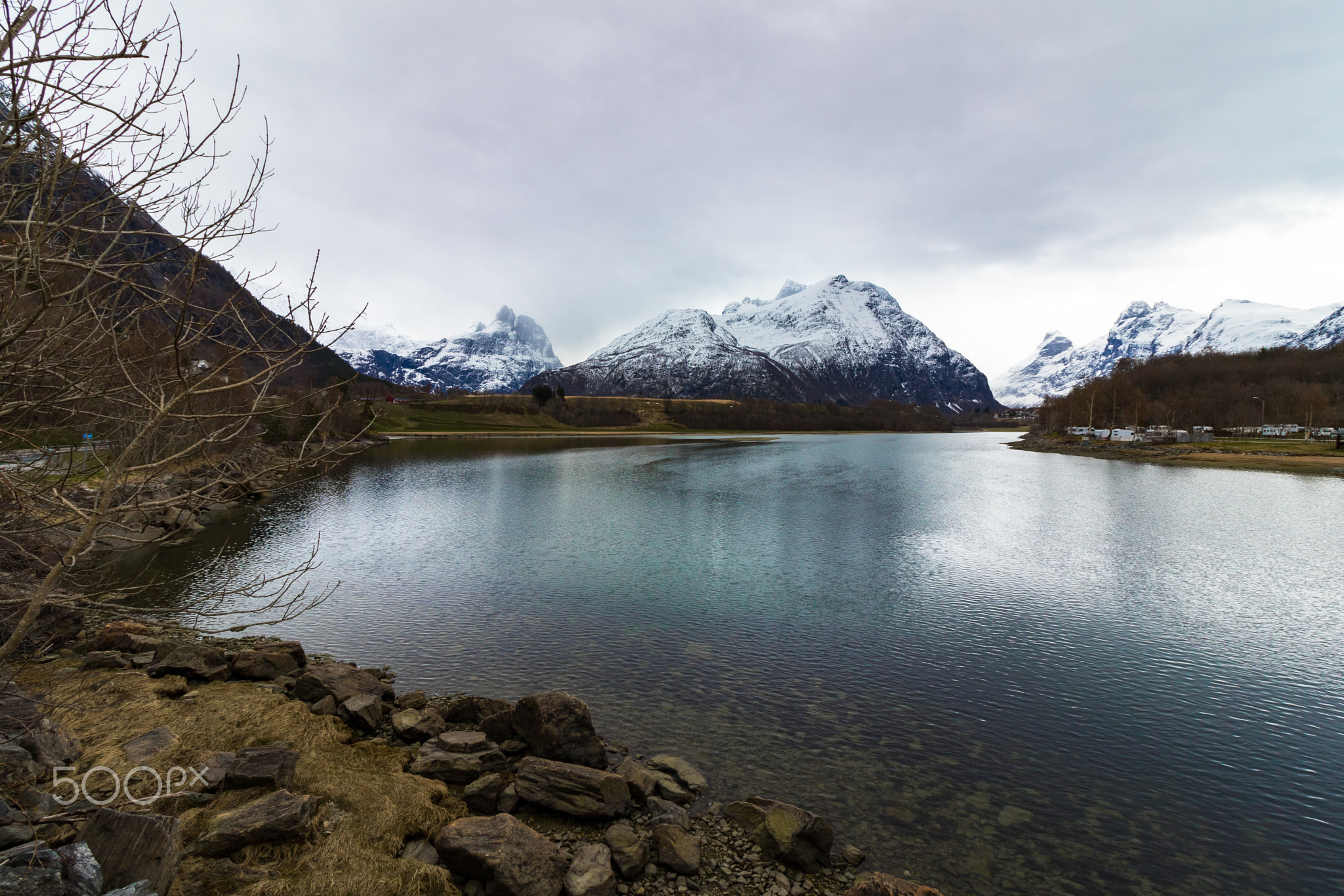 Rauma River with tall, snow covered mountains in the background.