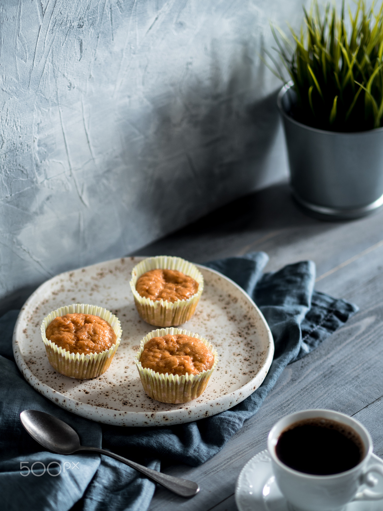 carrot muffins and coffee cup on gray wooden table