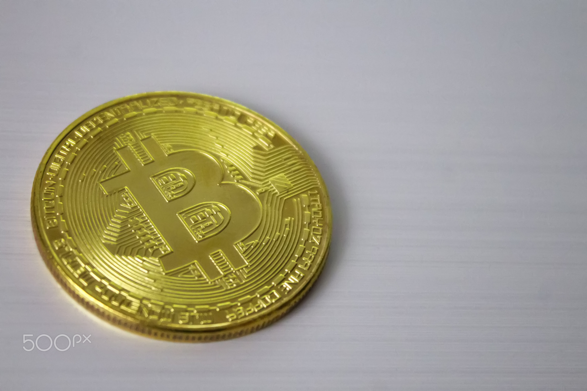 gold coin bitcoin on white background close-up