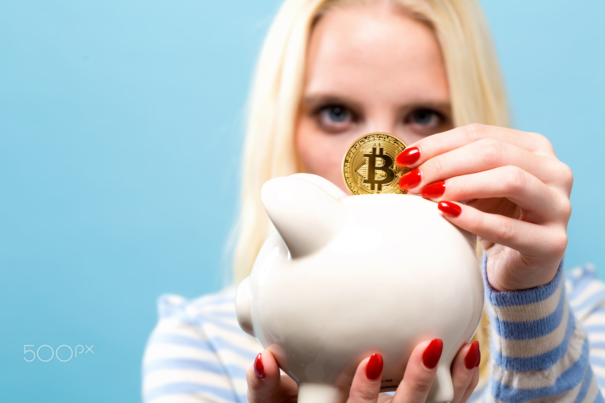 Woman with bitcoin and piggy bank