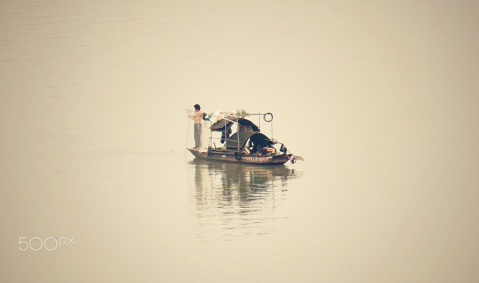 Sony E 55-210mm F4.5-6.3 OSS sample photo. A hard working fisherman photography