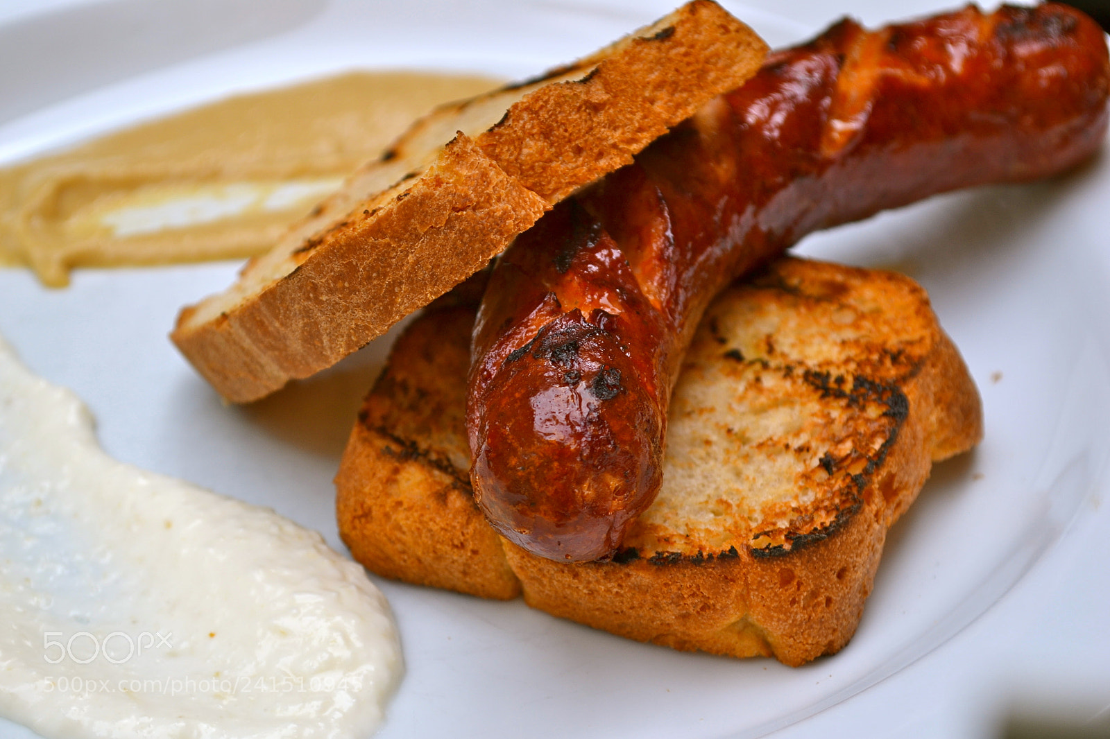 Nikon D3100 sample photo. Bratwurst on rustic bread. photography