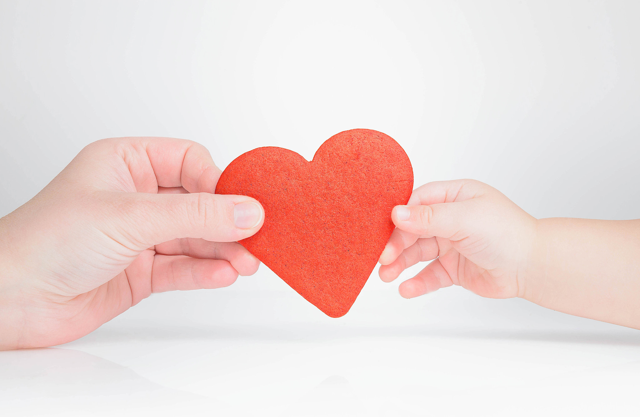 Mother gives the child the symbol of the red heart