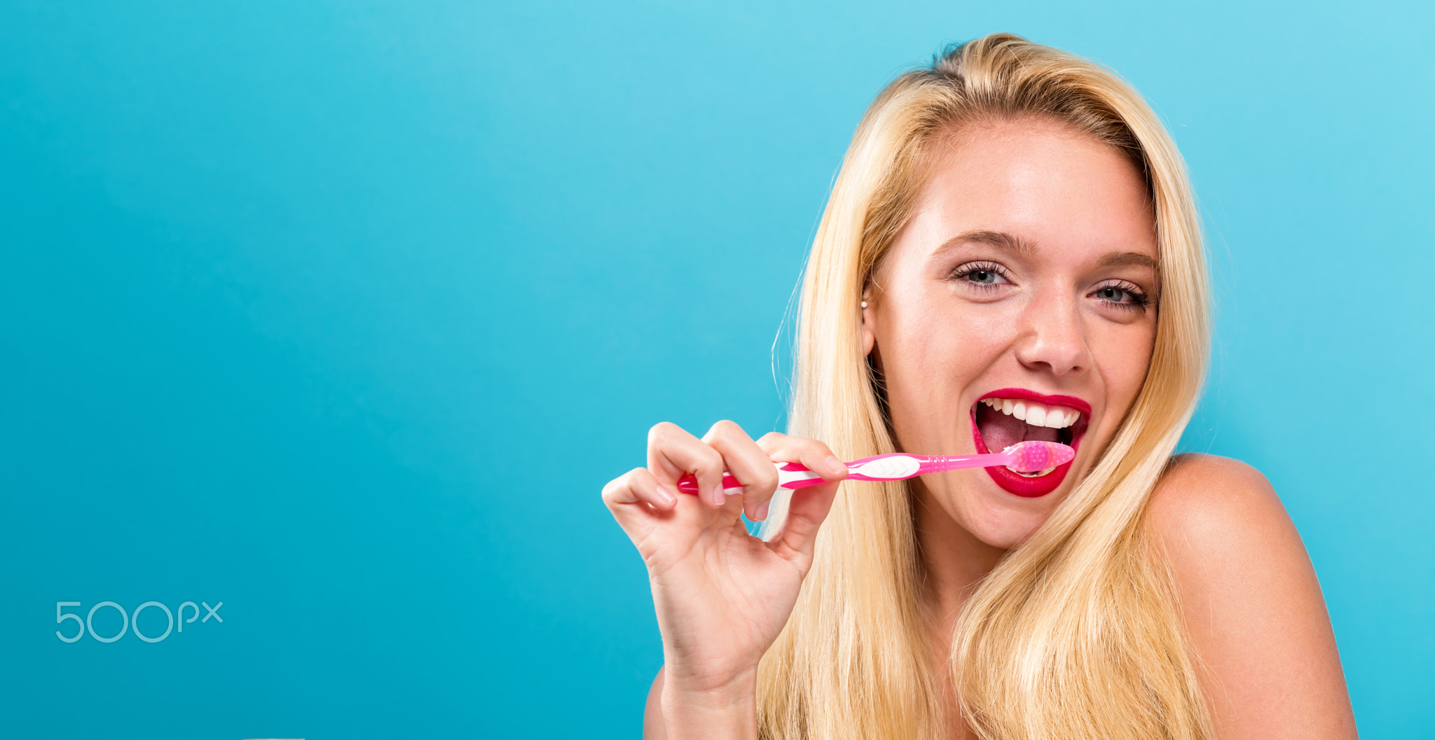Young woman holding a toothbrush