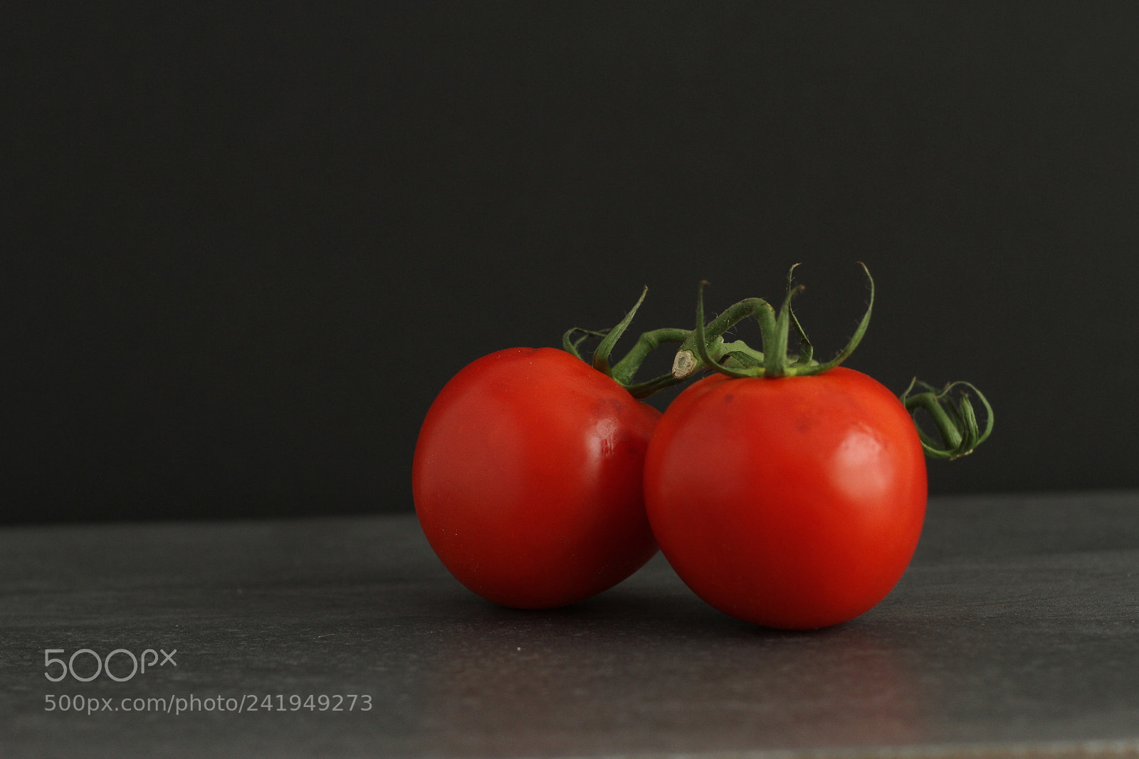 Canon EOS 7D + Canon EF 50mm F1.8 II sample photo. Tomatoes on black background photography