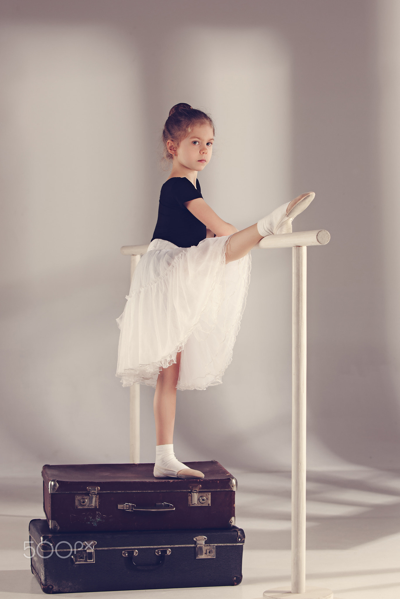 The little girl as balerina dancer standing at studio