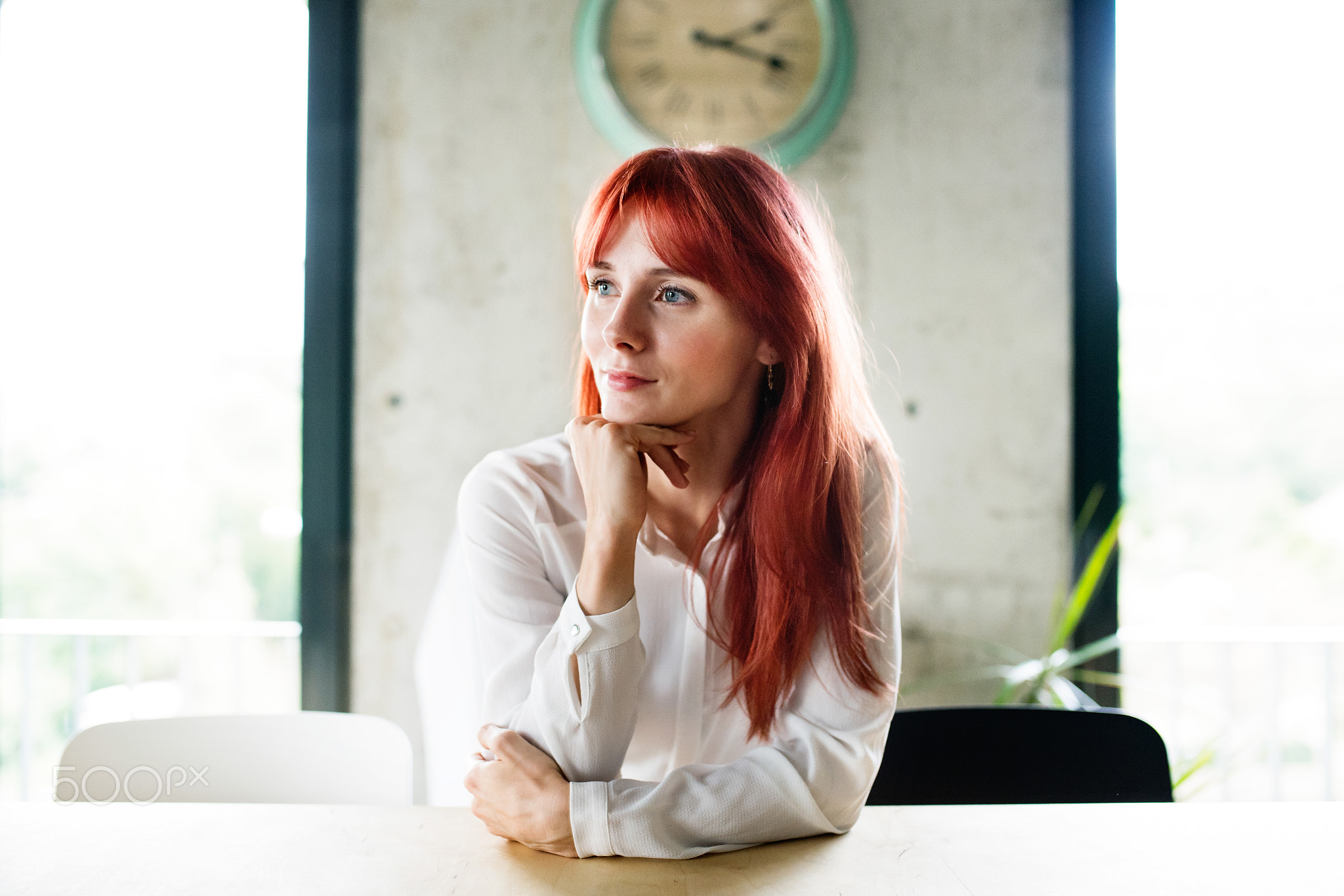 Businesswoman sitting at desk in her office.