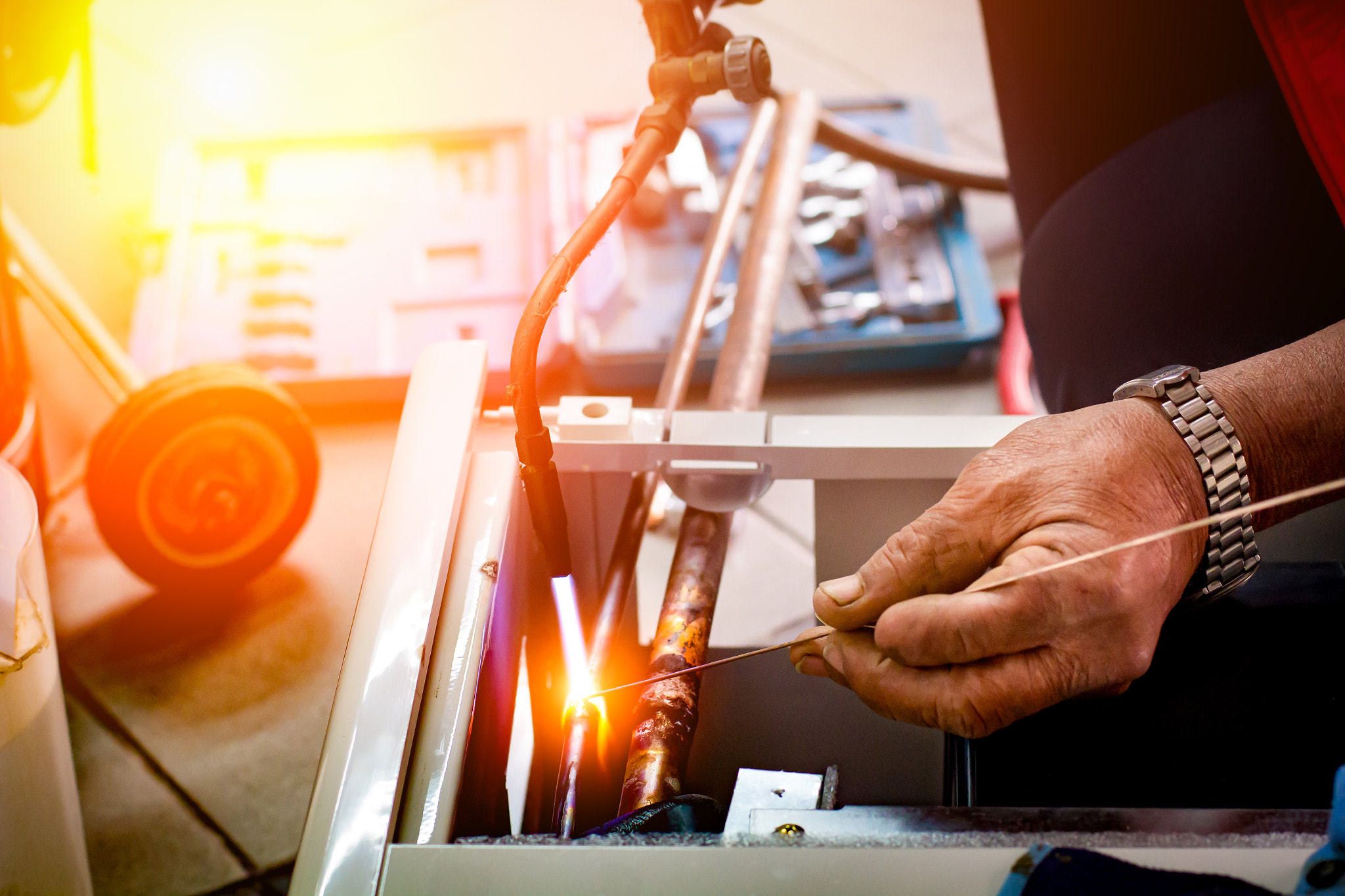 repairman soldering copper pipe gas burner for Air Conditioning