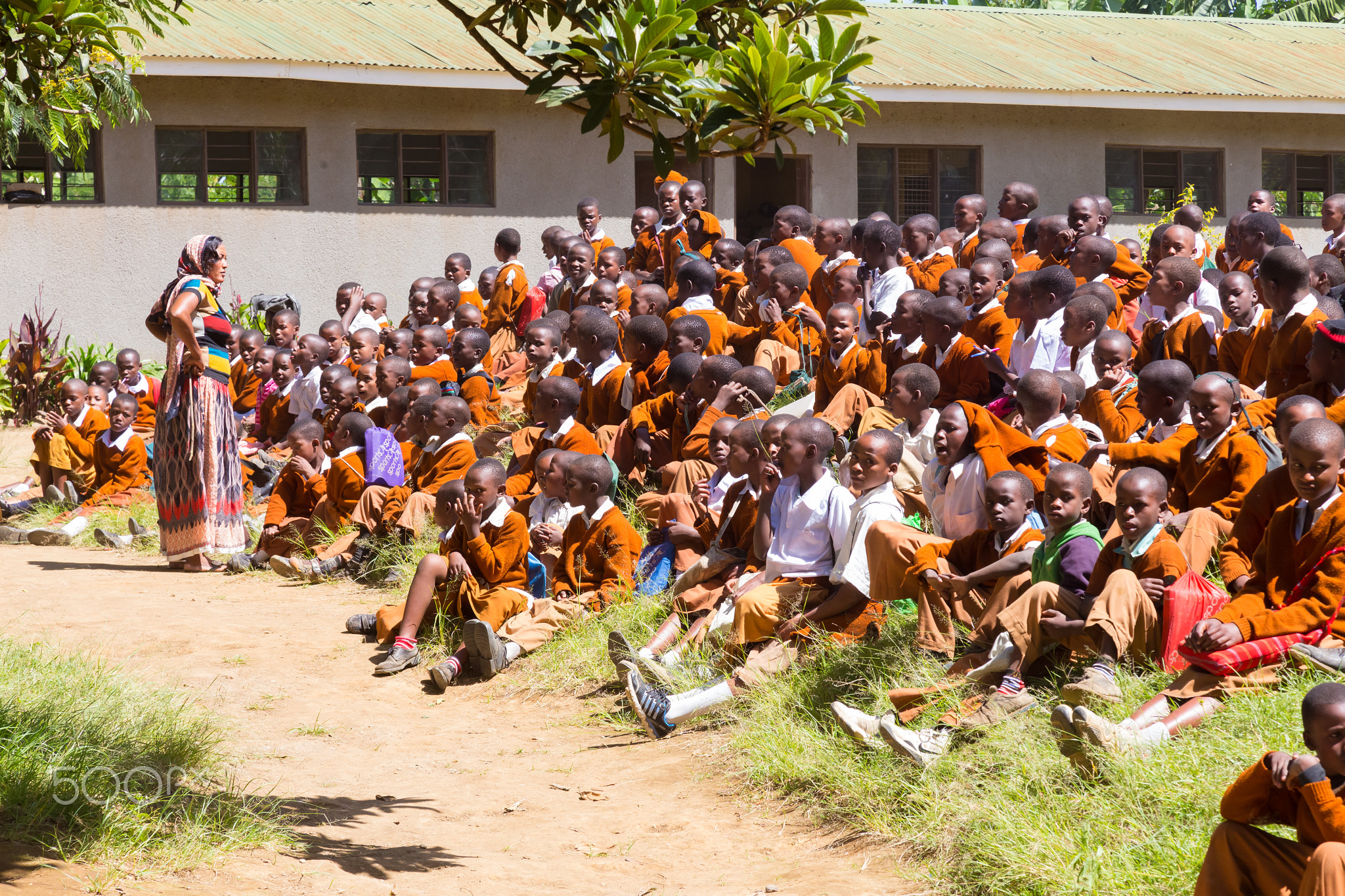 Children in uniforms playing in the cortyard of primary school in rural area near Arusha,...