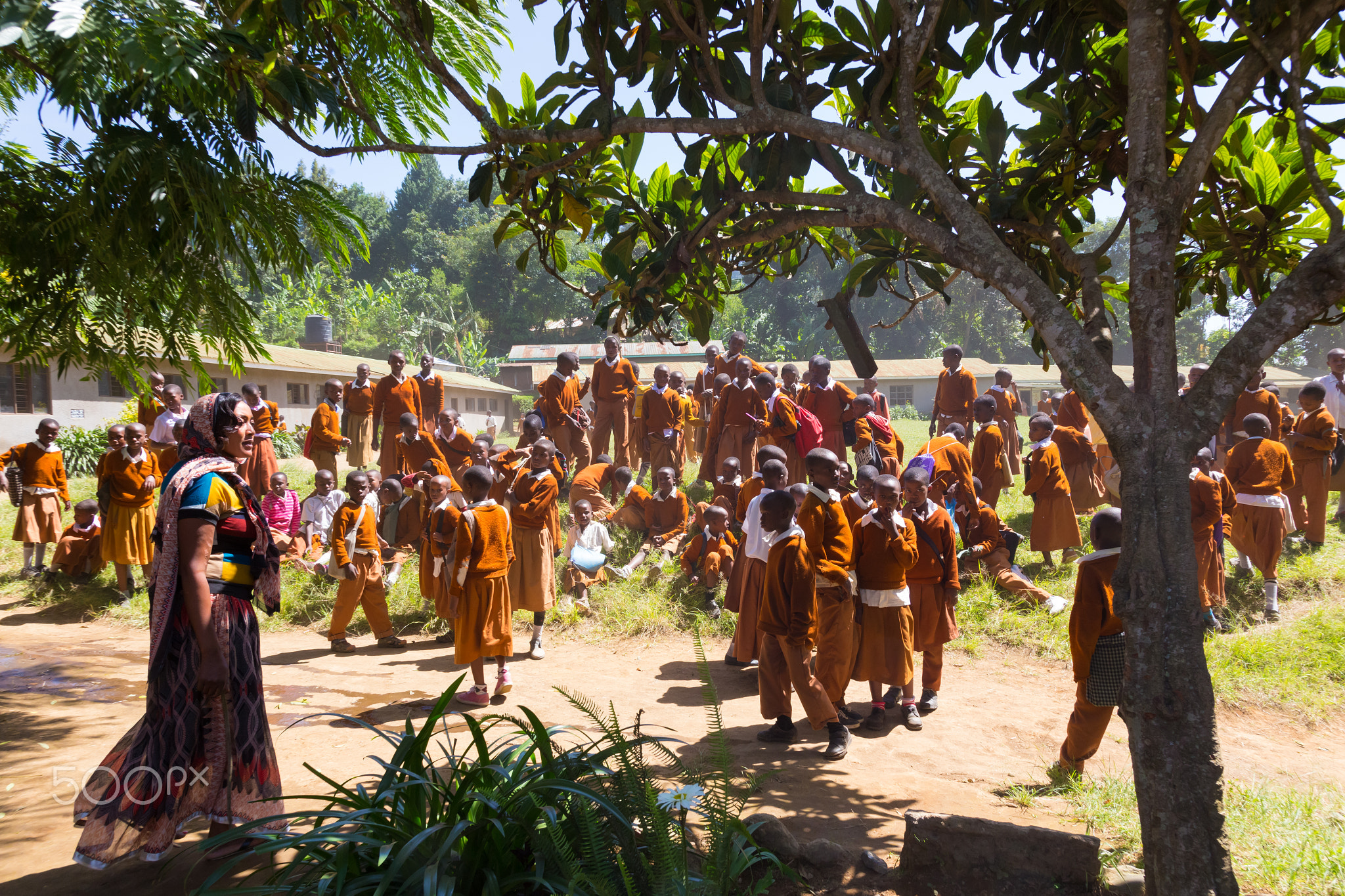 Children in uniforms playing in the cortyard of primary school in rural area near Arusha,...