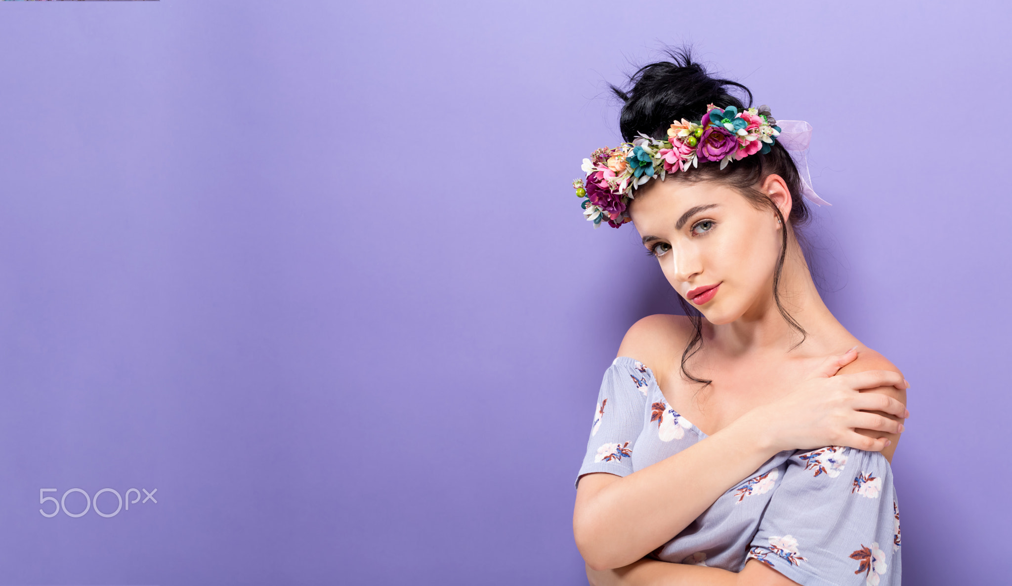 Beautiful young woman with a garland