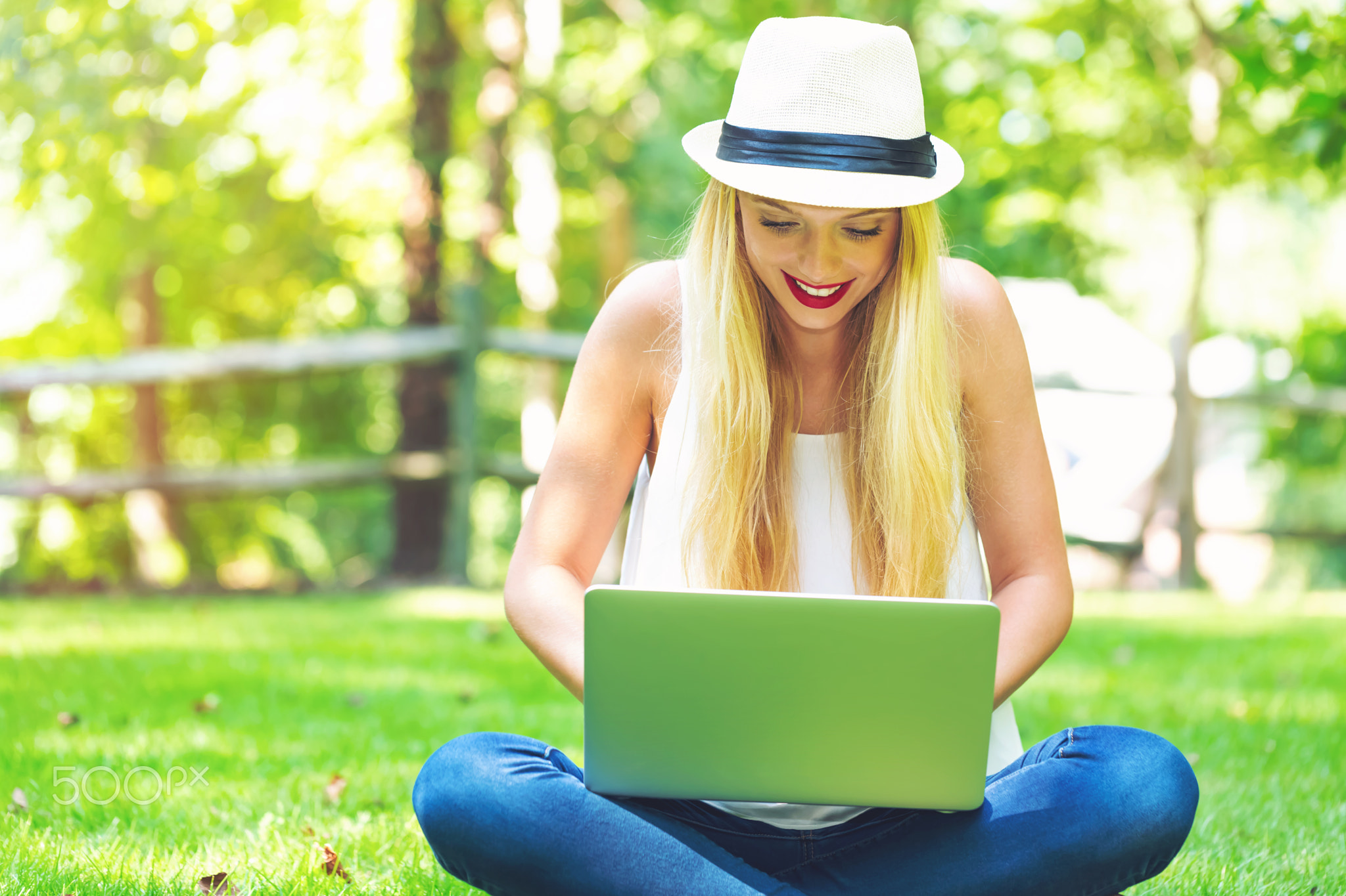 Young woman using her laptop outside