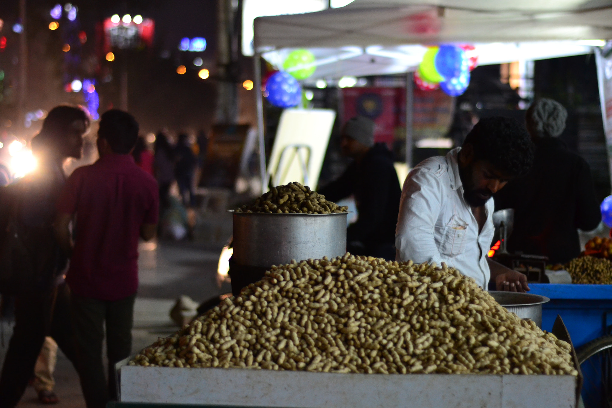 Nikon D3100 + Nikon AF Nikkor 50mm F1.8D sample photo. Hawker selling peanuts photography