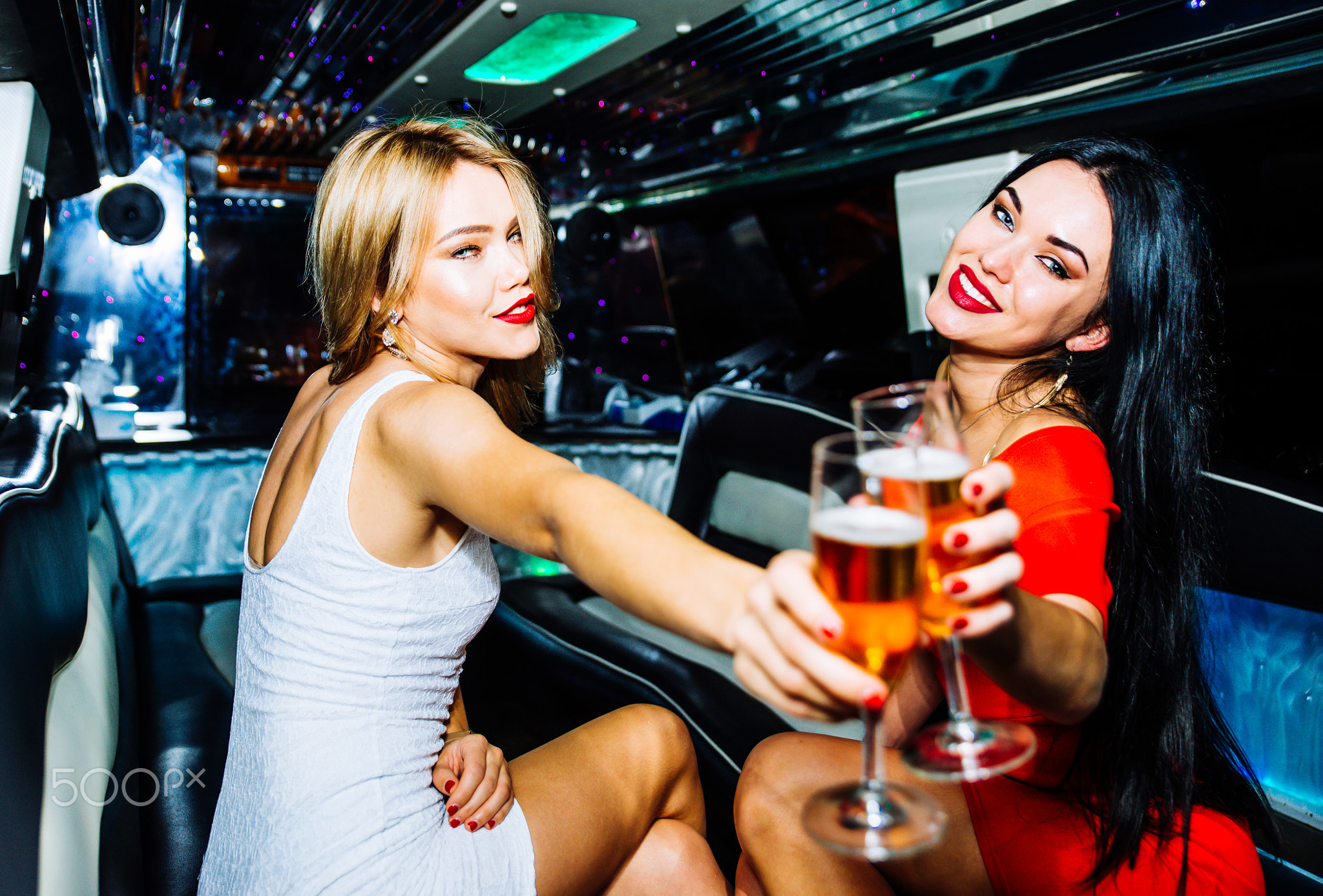 Beautiful girls making party in the limousine