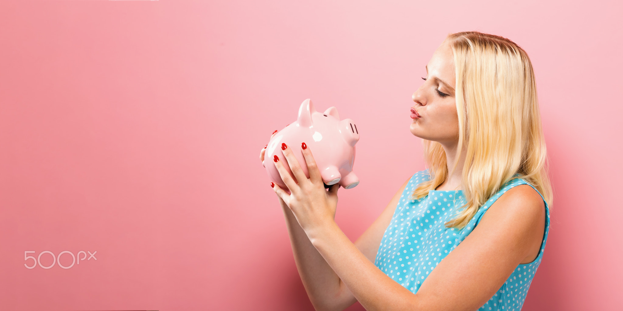 Young woman with a piggy bank