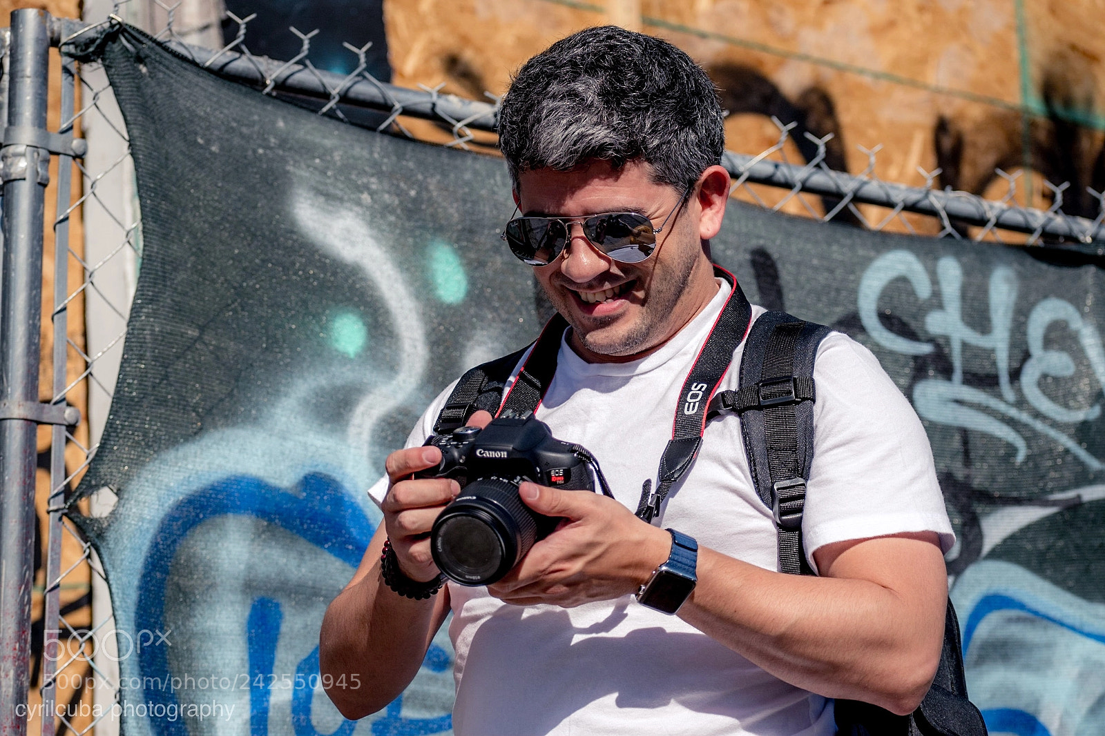 Nikon D5500 sample photo. Happy photographer reviewing pictures photography