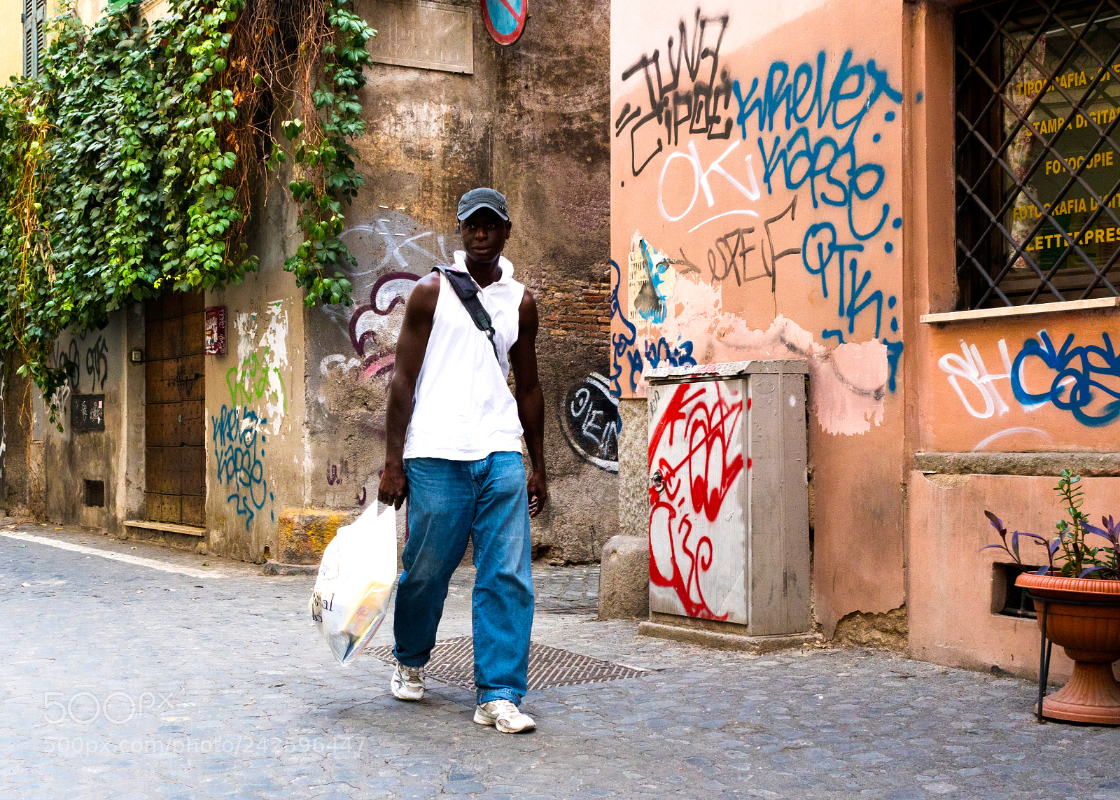 Sony a6500 sample photo. Man walking by graffiti photography