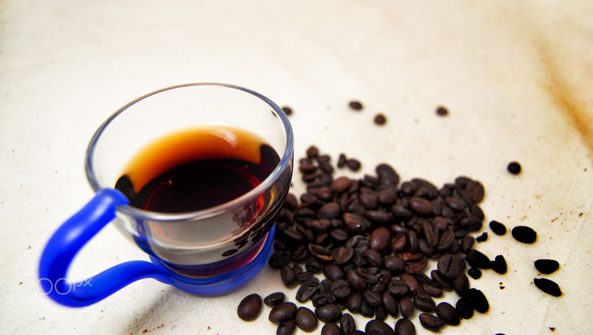 soft focus of a cup of energetic drink infusion and coffee beans with a raw background. for detox...